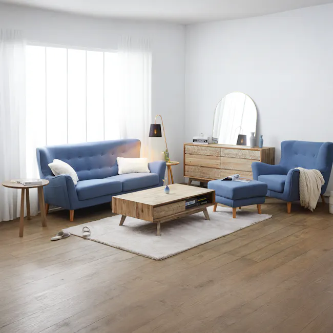 Leland Twin Drawer Coffee Table - 2 - Modern living room with blue tufted sofa, wooden coffee table, white fluffy rug, floor