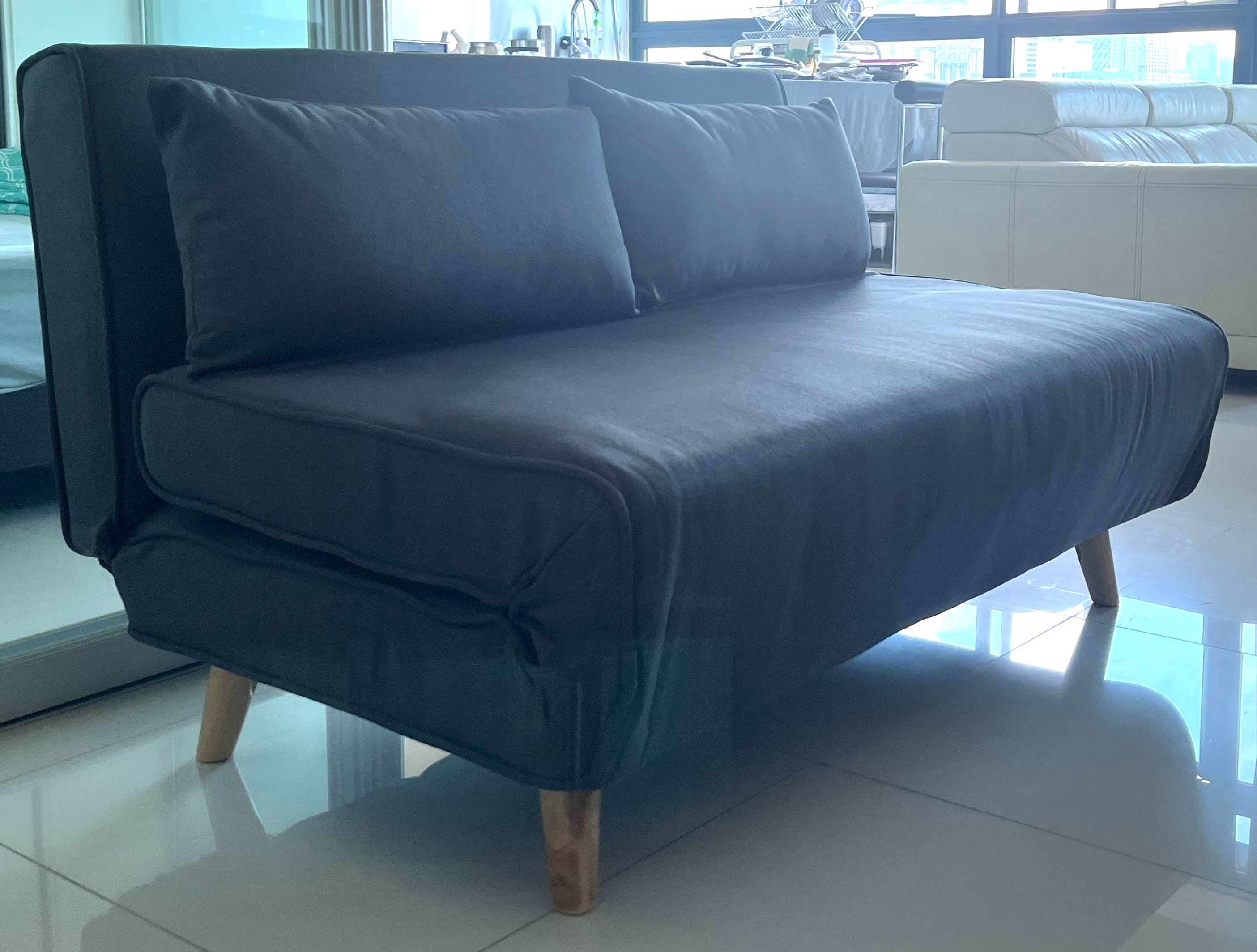 Customer home photo 3: The Noel 2-Seater Sofa Bed fits beautifully into a smaller space with its minimalistic, compact design. It doesn’t overpower the room and complements a clean, modern setup. Setup was easy — it came mostly assembled and just needed a few quick adjustments.

For the price, it definitely feels like good value. The fabric has a nice look and texture, and it’s comfortable enough for short-term use. We’ve had guests sleep on it for a couple of nights and they were quite okay with it.

That said, it’s not really a full-time sofa alternative. The seating is a bit low, and there’s a light creaking noise when sitting down or getting up. Also, the zippers don’t feel super sturdy, so I’m a little cautious about how it’ll hold up over time. But for occasional use, it serves its purpose well.