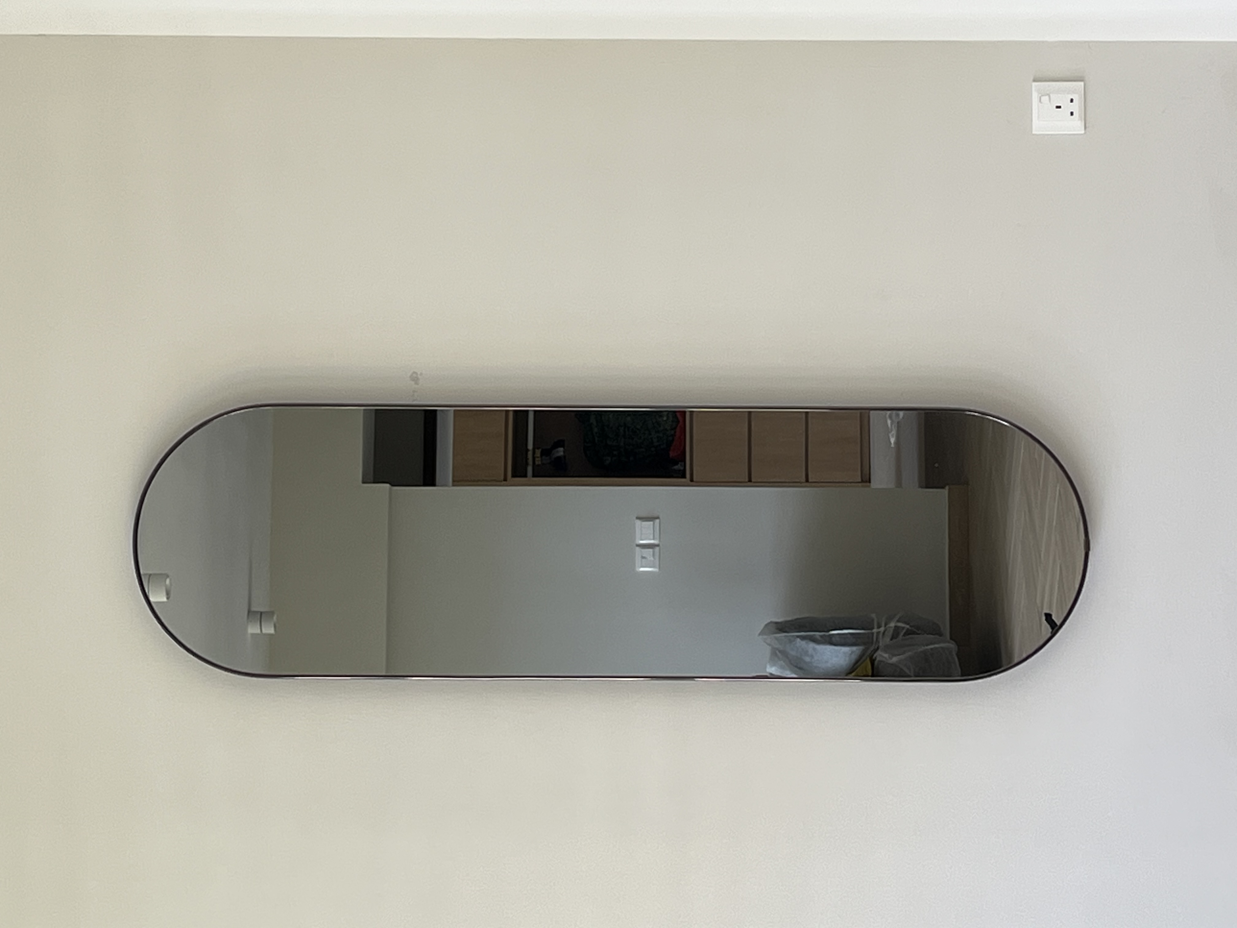 Customer home photo 1: Slim mirror which makes the living room more spacious and allows me to do a last min fit check before leaving home