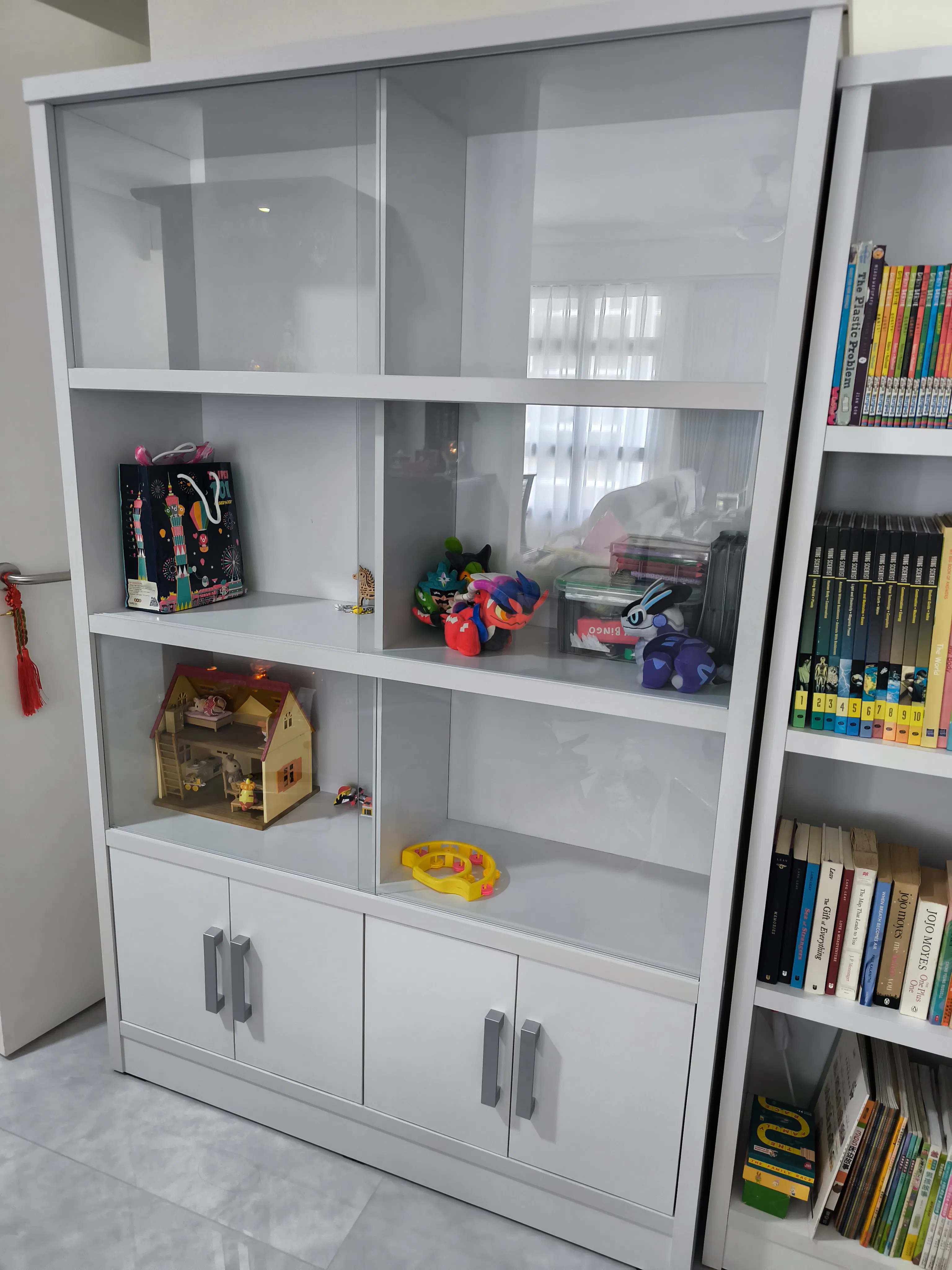 Customer home photo 1: Good product, this display shelf very spacious but the cabinet door has slight misalignment but still acceptable.
