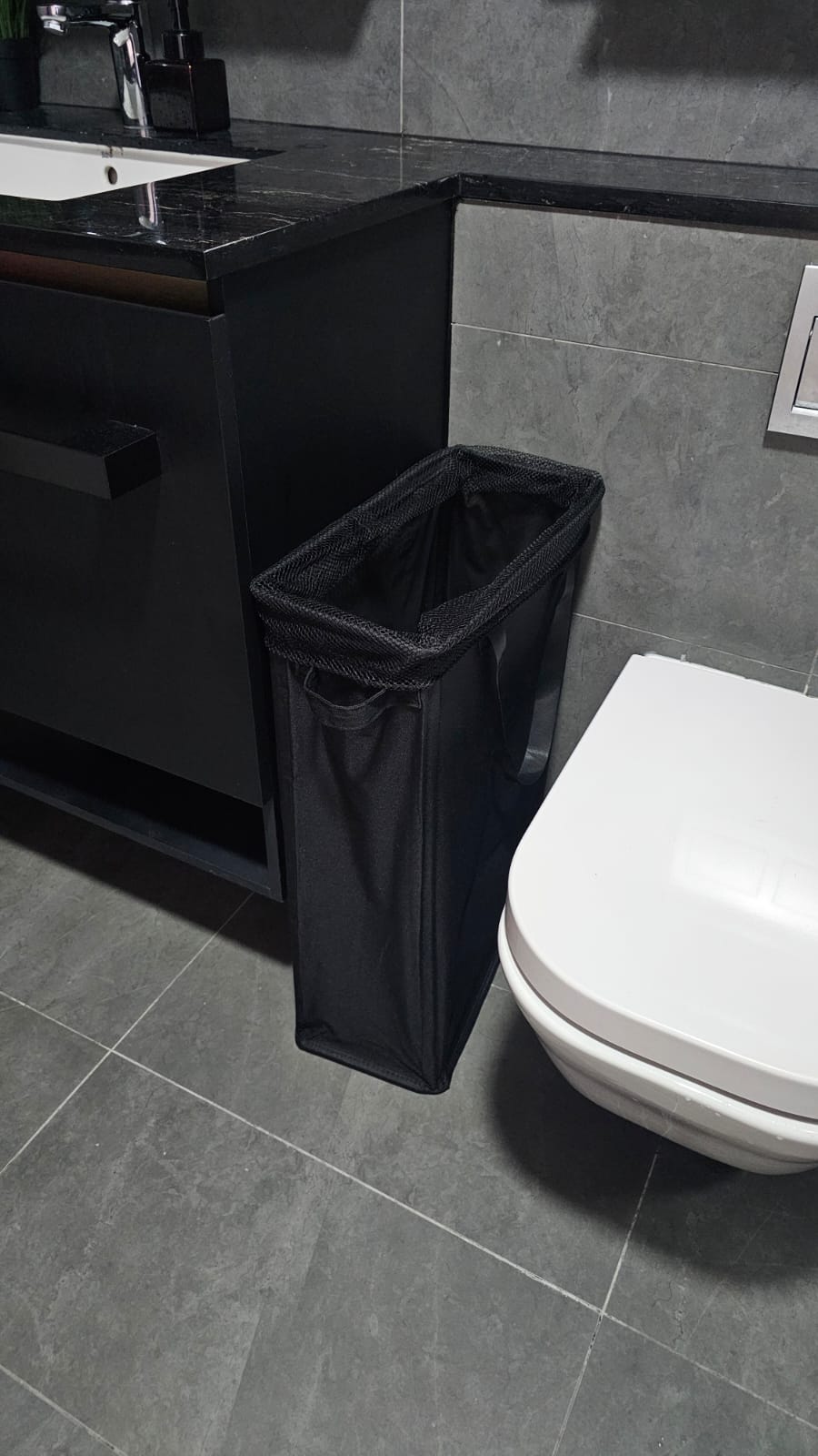 Customer home photo 3: Looked everywhere to find a laundry basket with this dimensions & was SO HAPPY to find this one - it fits perfectly in our bathroom. Quality of this laundry hamper is also great and it has all the right features: handles at the side to carry it to the washer, a little handle in front to pull it out and push it back in, and drawstring at the top to close it up when we need to (e.g. when guests come over).