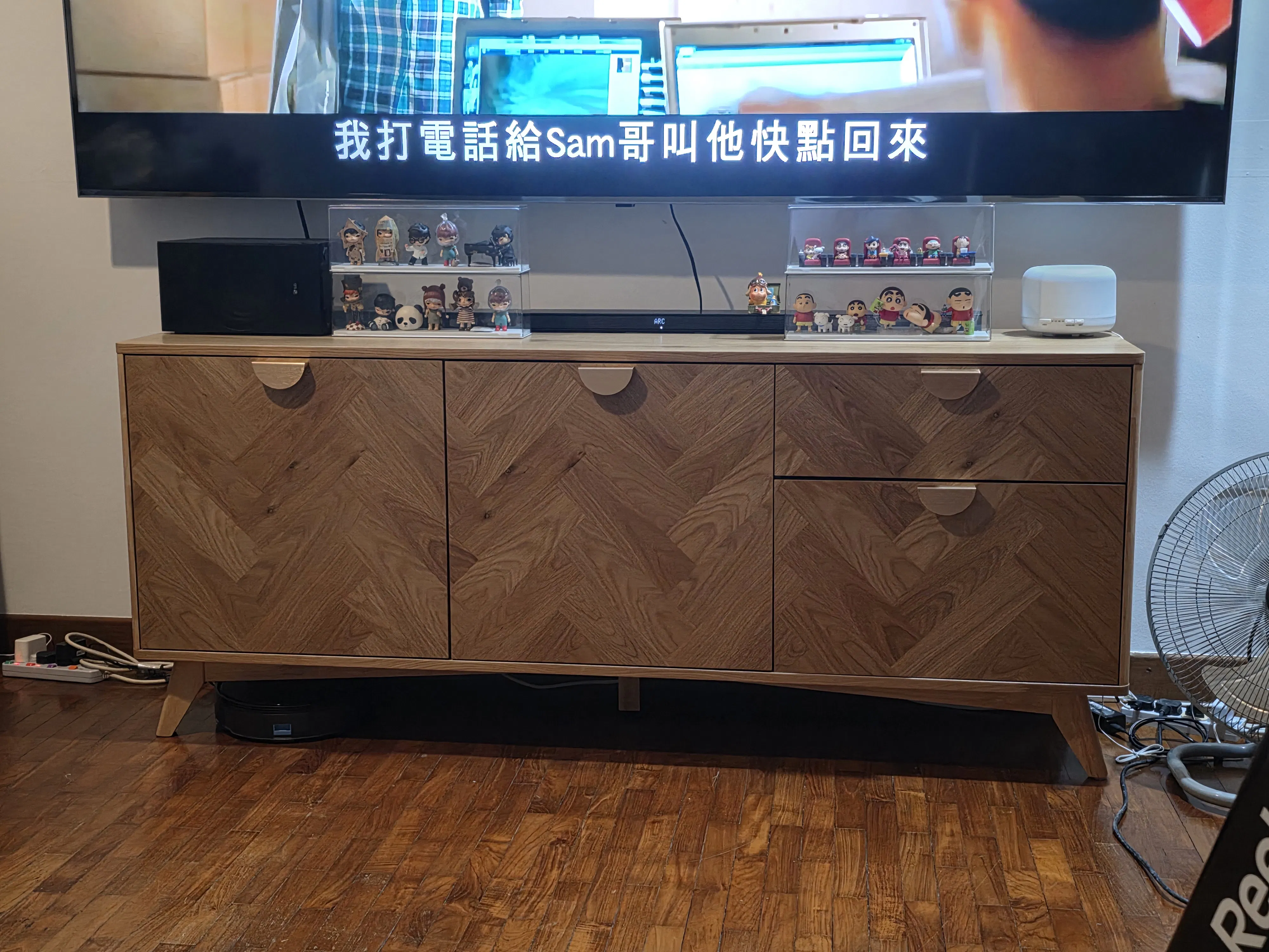 Customer home photo 1: This sideboard has an interesting laminate. It is sturdy and stores much. The legs also allow for easy cleaning  of thefloor below the sideboard