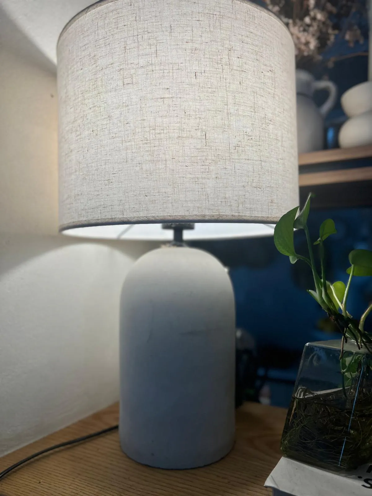 Customer home photo 8: Nice Table Lamp with soft glow fabric lampshade and natural cement like base.