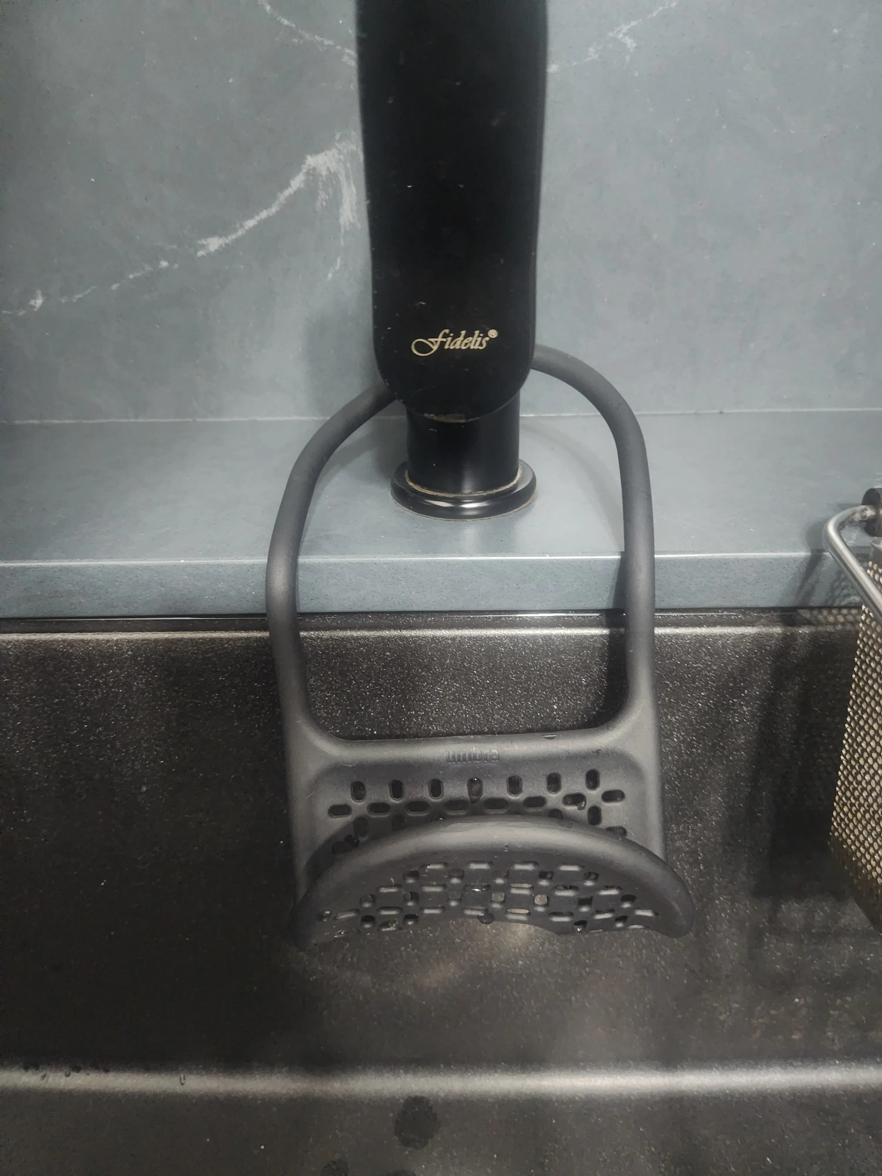 Customer home photo 4: Simple looking black sponge holder that goes well with a black sink