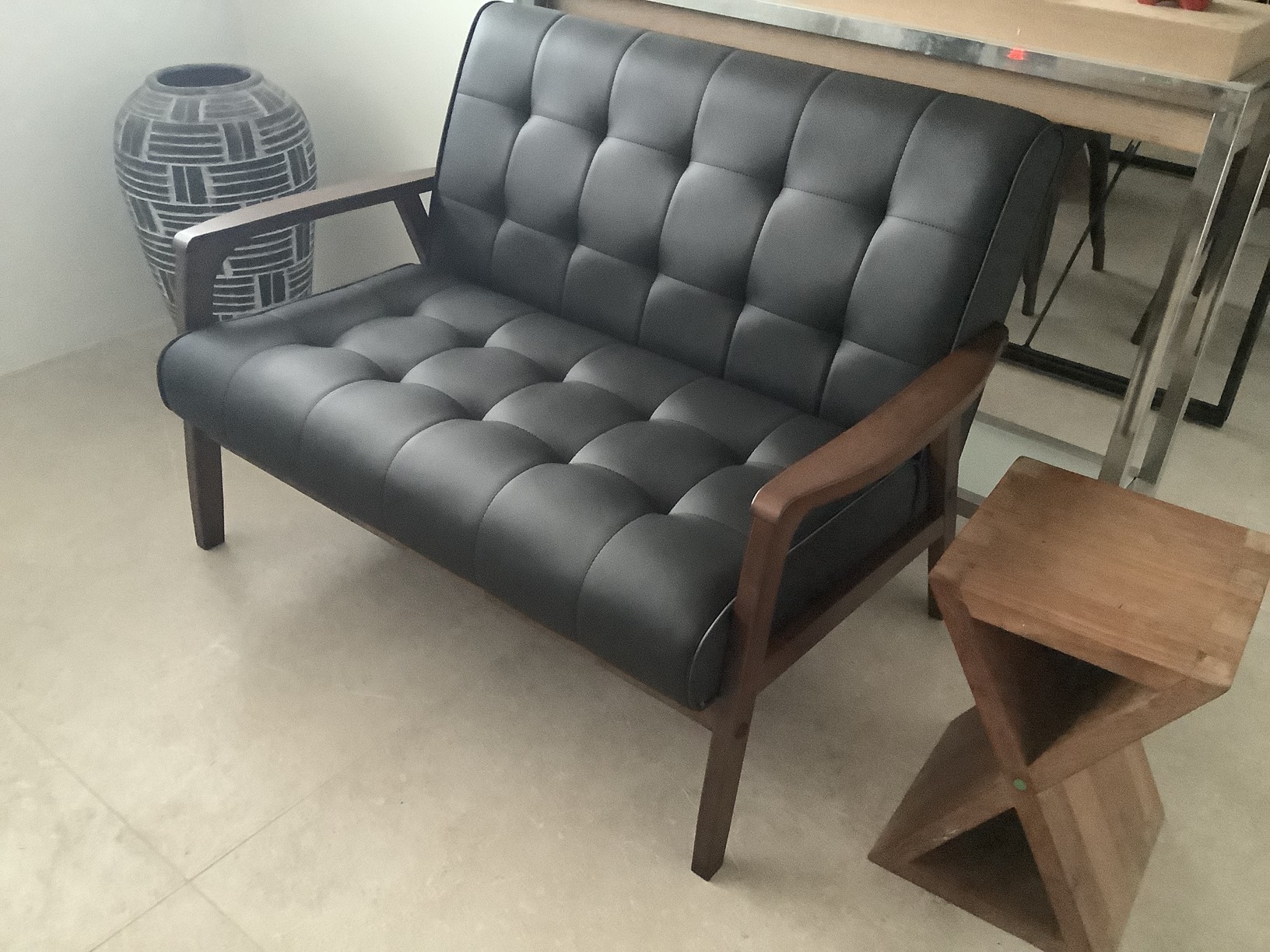 Customer home photo 2: Delivery was on time and assembling was fast. The two-seater looks classic, and the faux leather is odorless and neat. The leather cushion is very firm, and comfort level is fine. Sitting position is more upright than lazy posture. Adding small soft back support cushion will increase comfort level and overall, I think money is well spend.