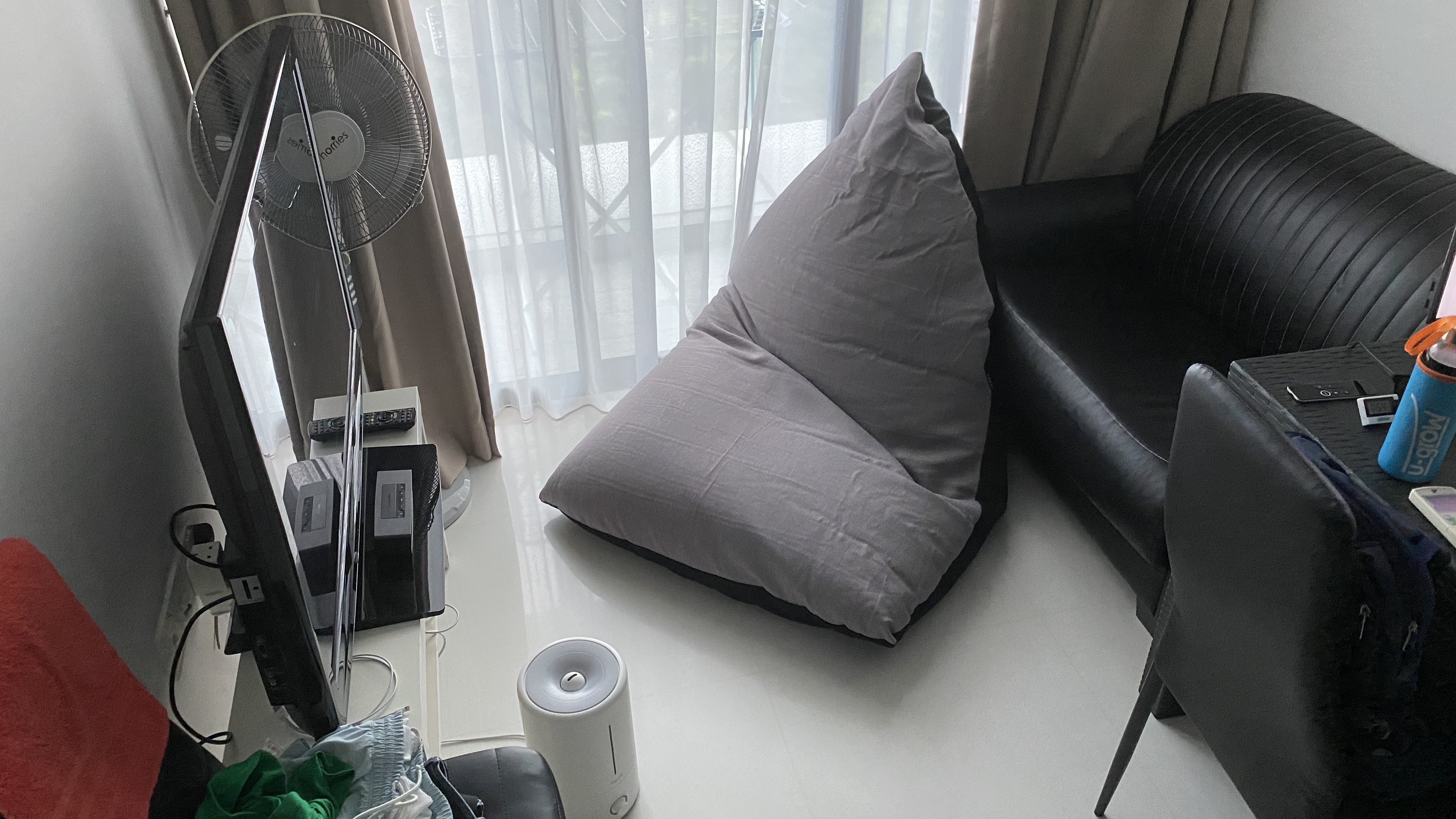 Customer home photo 1: Not washable, which is a bummer, but it's quite comfy and easy to get into a comfortable position. Be prepared though, it's much bigger than I expected it to be, so you need room for it