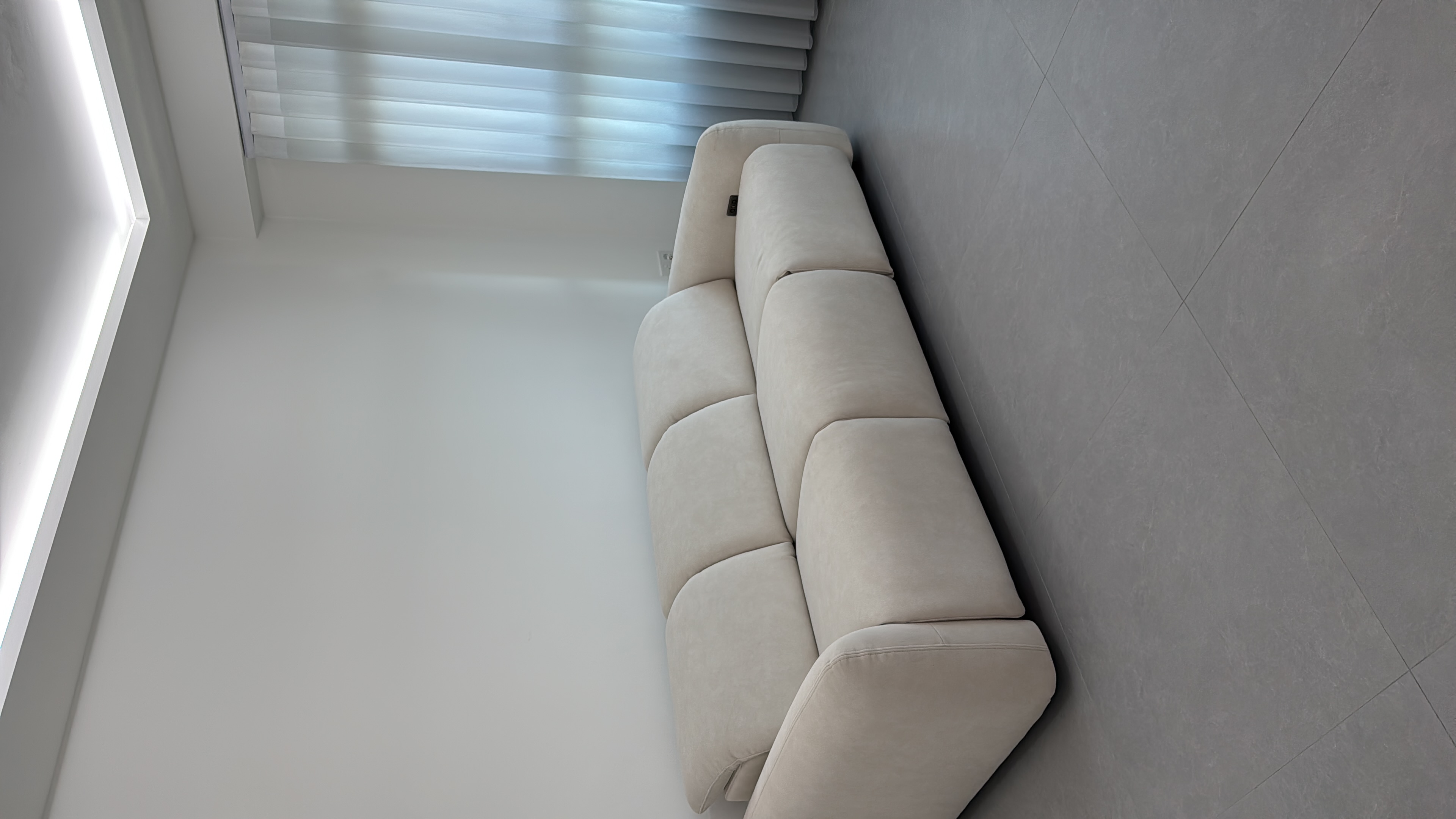 Customer home photo 4: Love it! So comfy, material is good, and pretty sturdy. The only downside is the plug for recliner is on one side which is far from our switch and sticks out abit but overall still looks good.