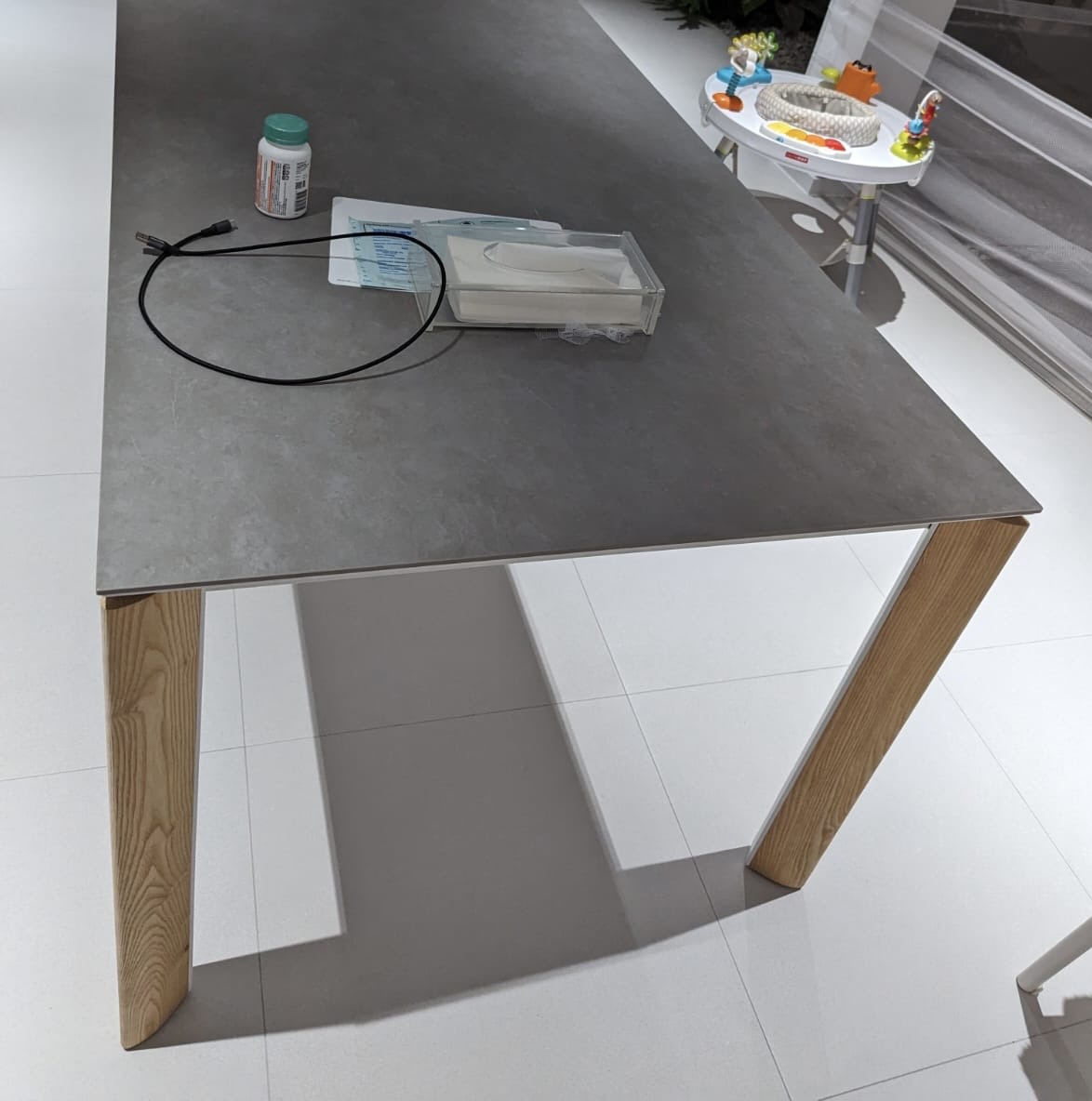 Customer home photo 1: Beautiful table that is good value for money. Sintered stone surface is stain resistant and easy to clean. White metal frame with solid wood legs is functional and pleasing to the eye. Great buy!