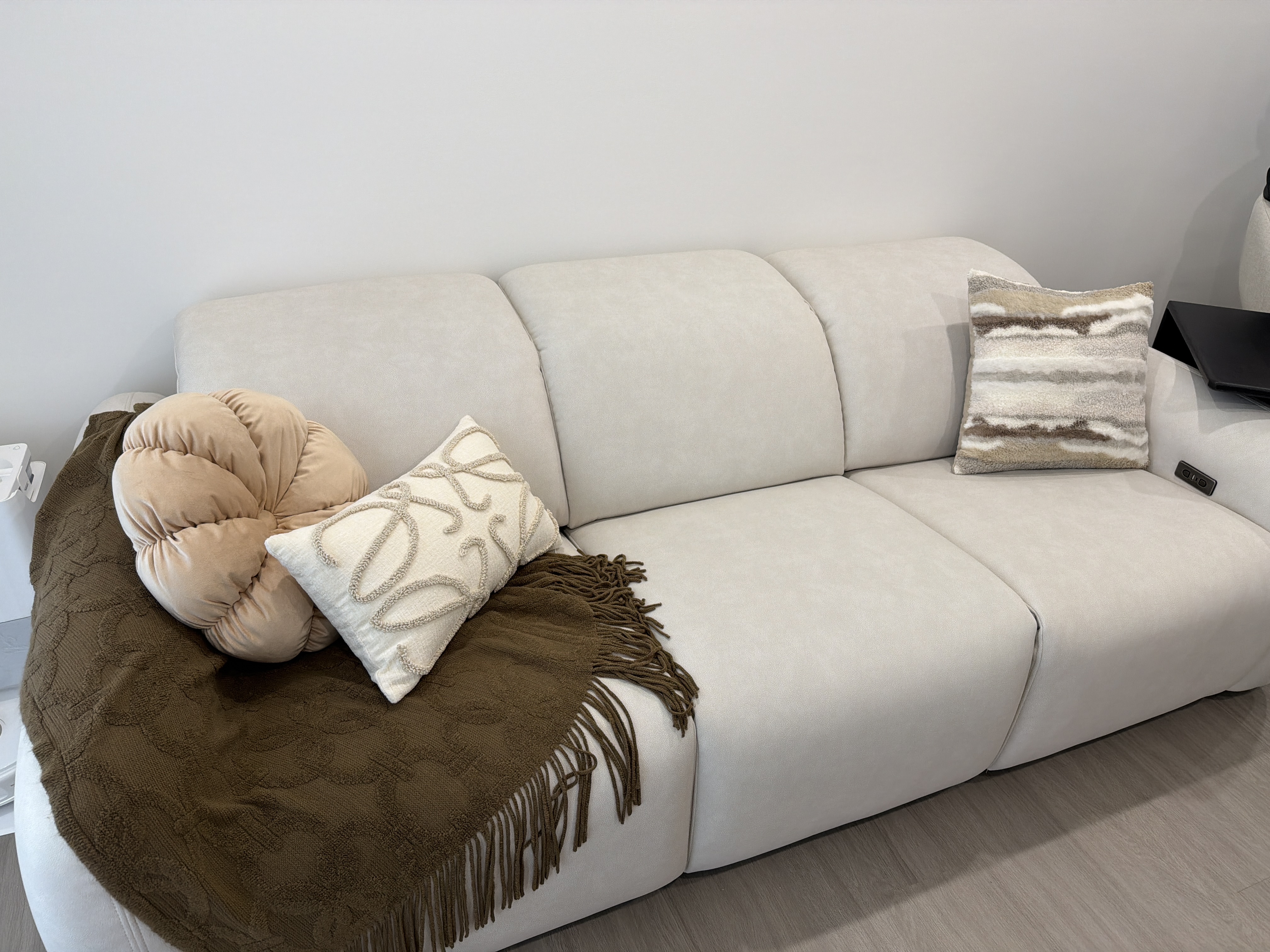 Customer home photo 3: Love everything about this sofa - the colour, fabric and just how it fits so seamlessly into our home. Also styled it a little with cushions and a throw! Absolutely love this, highly recommend!!!