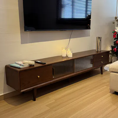 Customer home photo 1: It’s beautiful. The corners are rounded. The legs come with felt padded stickers. There are holes at the back for cable access. I was easily able to put in an entire large power extension through it.
The quality is good, the wood is smooth and even the hardware is well-finished.