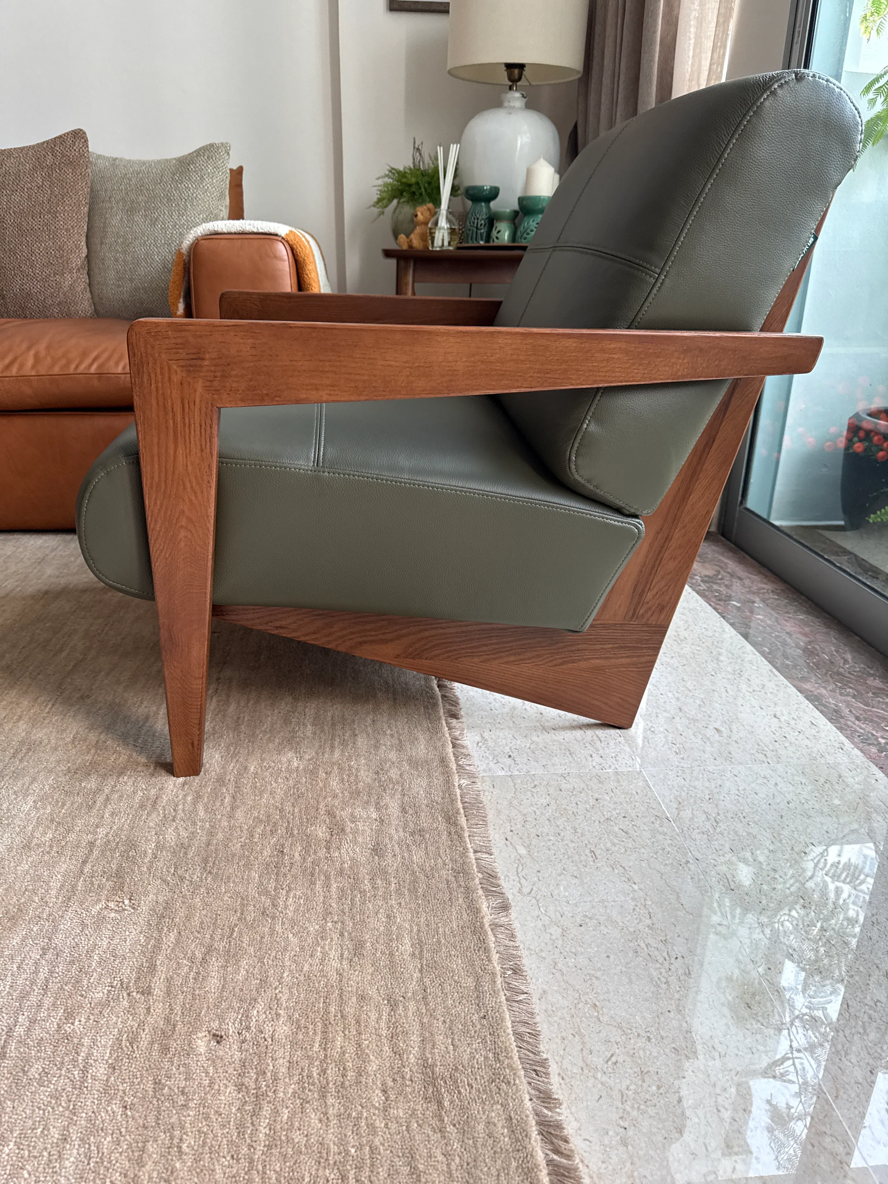 Customer home photo 1: Love the stylish design & moss green color ! The cushion is firmly soft & comfortable. Workmanship is good. Bought 1 piece initially as wasn’t sure about comfort level but having sat on it, immediately went to purchase  another chair to complete the look! So happy with purchase.