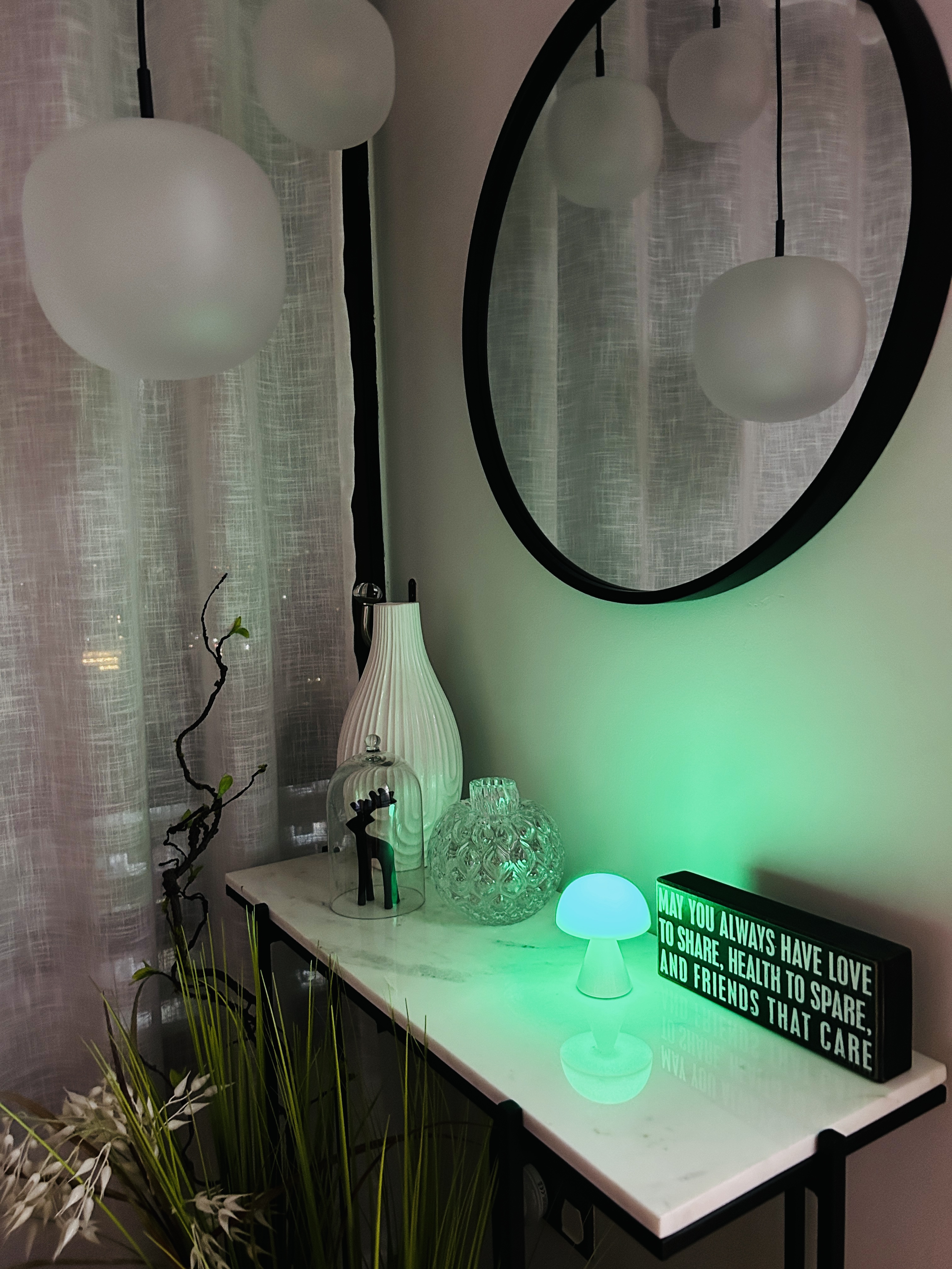 Customer home photo 1: The Lexon MINA M LED Lamp is both stylish and playful, designed to brighten your space while matching your mood. With its ability to change colors, it adds a touch of personality and fun to any setting. In its glossy white standalone form, the lamp feels effortlessly minimalist and timeless—clean, classic, and easy on the eyes. It’s the kind of design you won’t get tired of looking at, making it a versatile addition to any room.