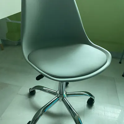 Customer home photo 3: Love the colour of the chair. It is comfortable as it cones with a cushioned seat pad and is very easy to assemble. The wheels make slight squeaky sound sometimes though.