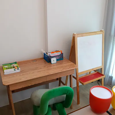 Customer home photo 1: Good quality and sturdy wooden table. Has 2 drawers that are useful for storing stationary.