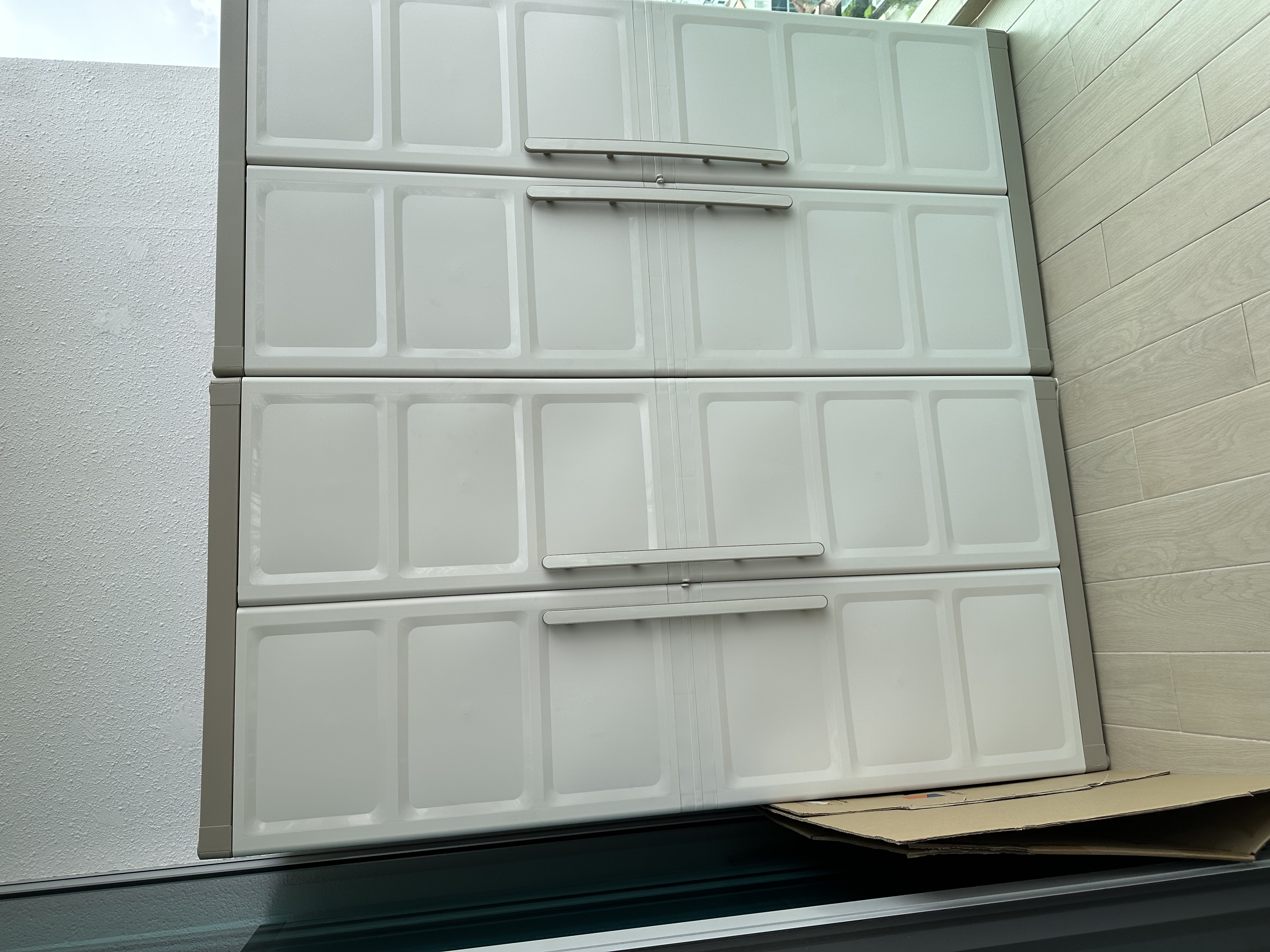 Customer home photo 1: This is the 2nd one that I had bought in less than 1 month.  The outdoor cabinet is great for storage.  Now my balcony looks tidy and spacious.