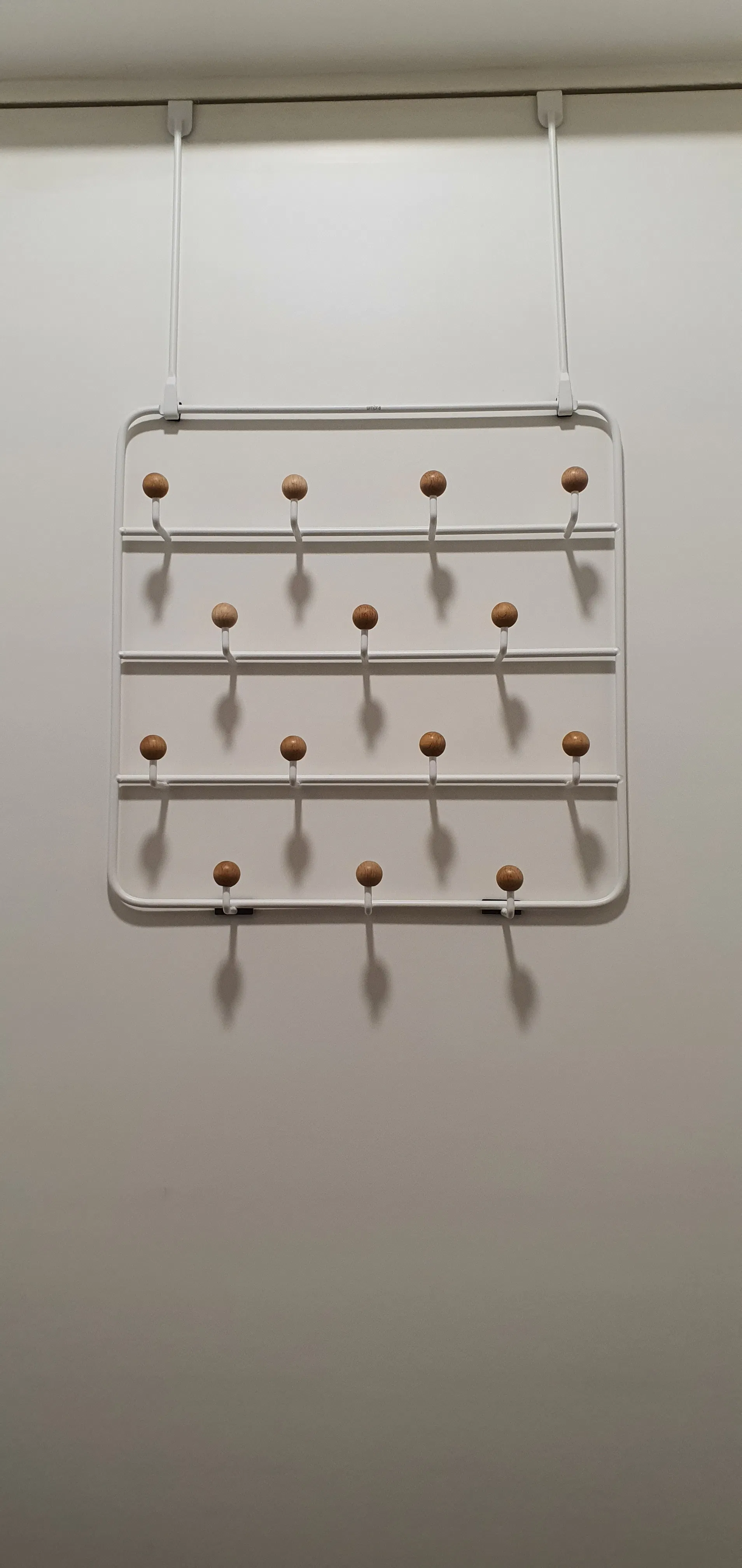 Customer home photo 4: I love this ovee the door organiser as there are many hooks compared to the usual over the door hangers.