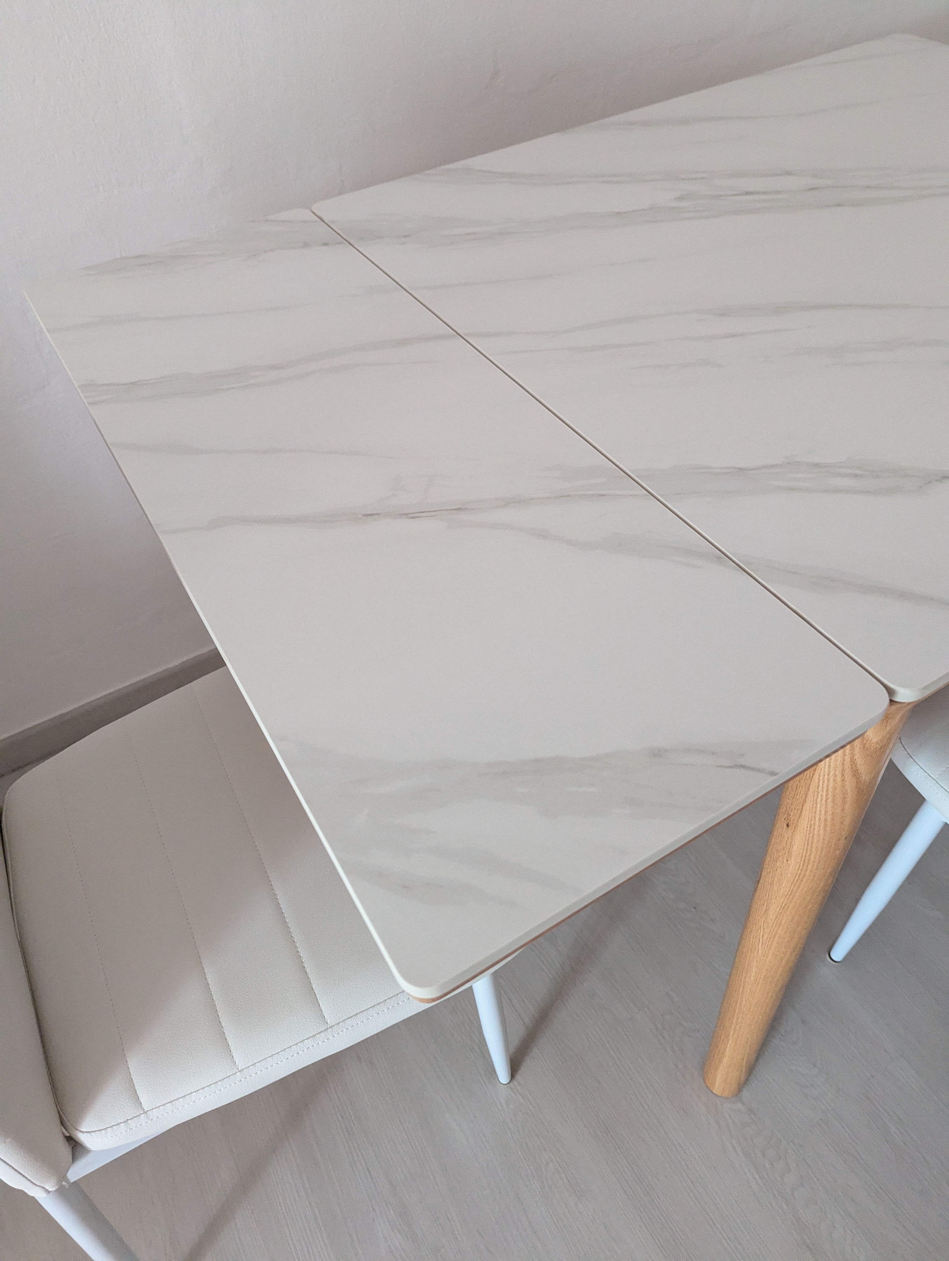 Customer home photo 1: The table feels really solid and sturdy. The sintered stone top is thicker than other tables I've viewed. And it is not difficult to extend the sides to it's full length - a single person can do it easily. Very satisfied with this purchase.
