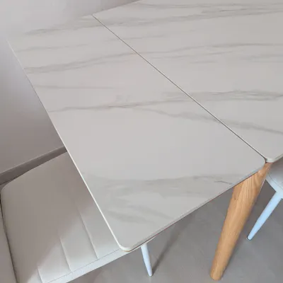 Customer home photo 1: The table feels really solid and sturdy. The sintered stone top is thicker than other tables I've viewed. And it is not difficult to extend the sides to it's full length - a single person can do it easily. Very satisfied with this purchase.
