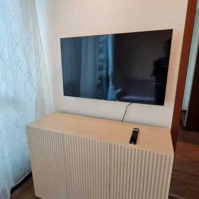 Customer home photo 69: I love this cabinet which is perfect for my 43 inch TV. The wood feels sturdy and the installer from GoGo max did a great job.