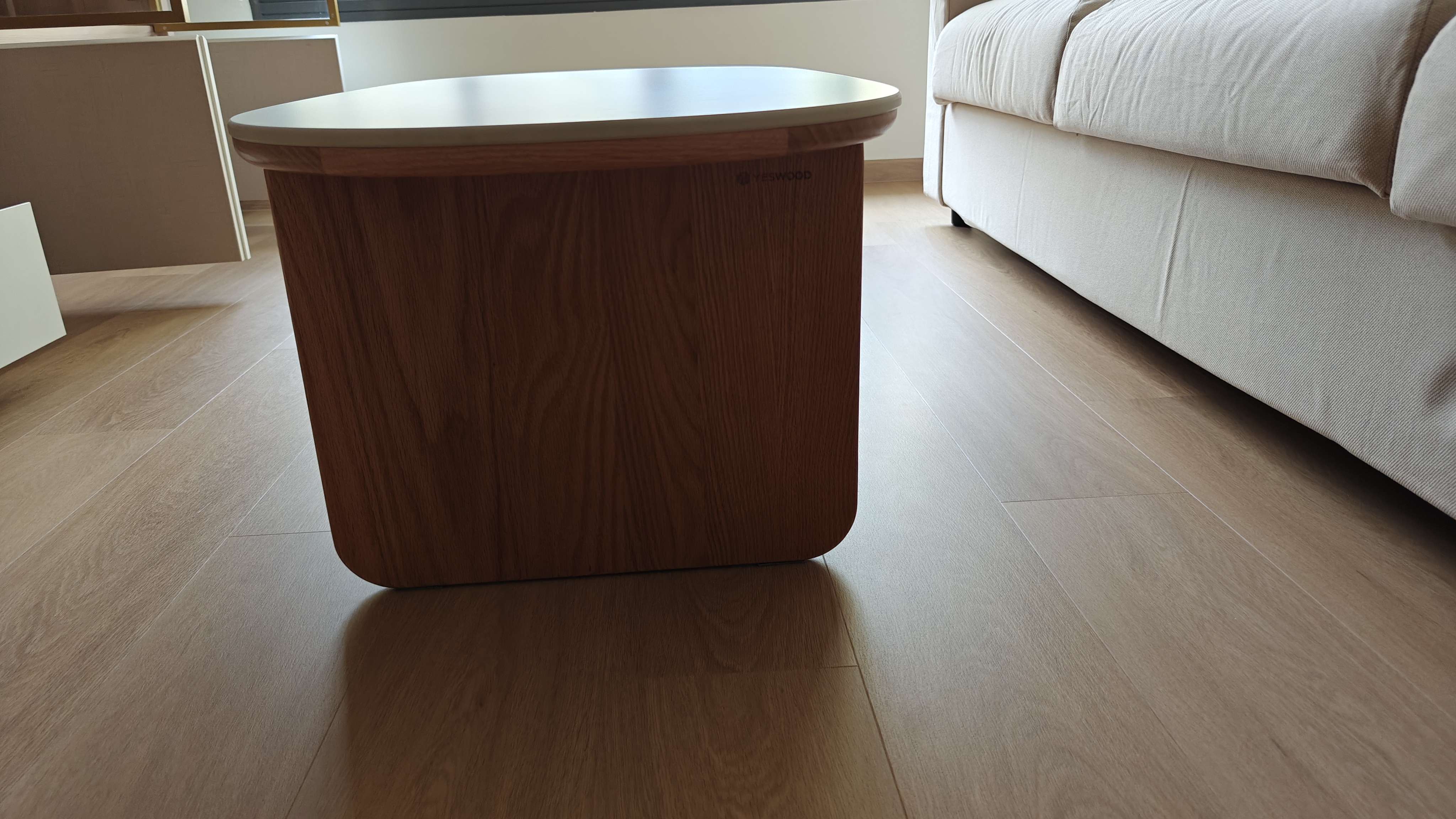 Customer home photo 11: A simple design that goes with your wooden pieces that have a ligher/reddish accent. The sintered stone top is solid and its edges have a rounded finish, making it comfortable to use and easier on the shin if you knock into it. Despite its size, the table is pretty hefty, so no worries there about kids or fur babies pushing it around. 

The table comes with 2 drawers which seem rather shallow, but this size is sufficient to store remote controls and stationery, and prevents clutter too! The drawers hinges are smooth to operate and allow the drawers to be closed with minimal noise.

And the wood gives off no atrong or strange smells, so that wraps up the 5/5 review I'm giving it!