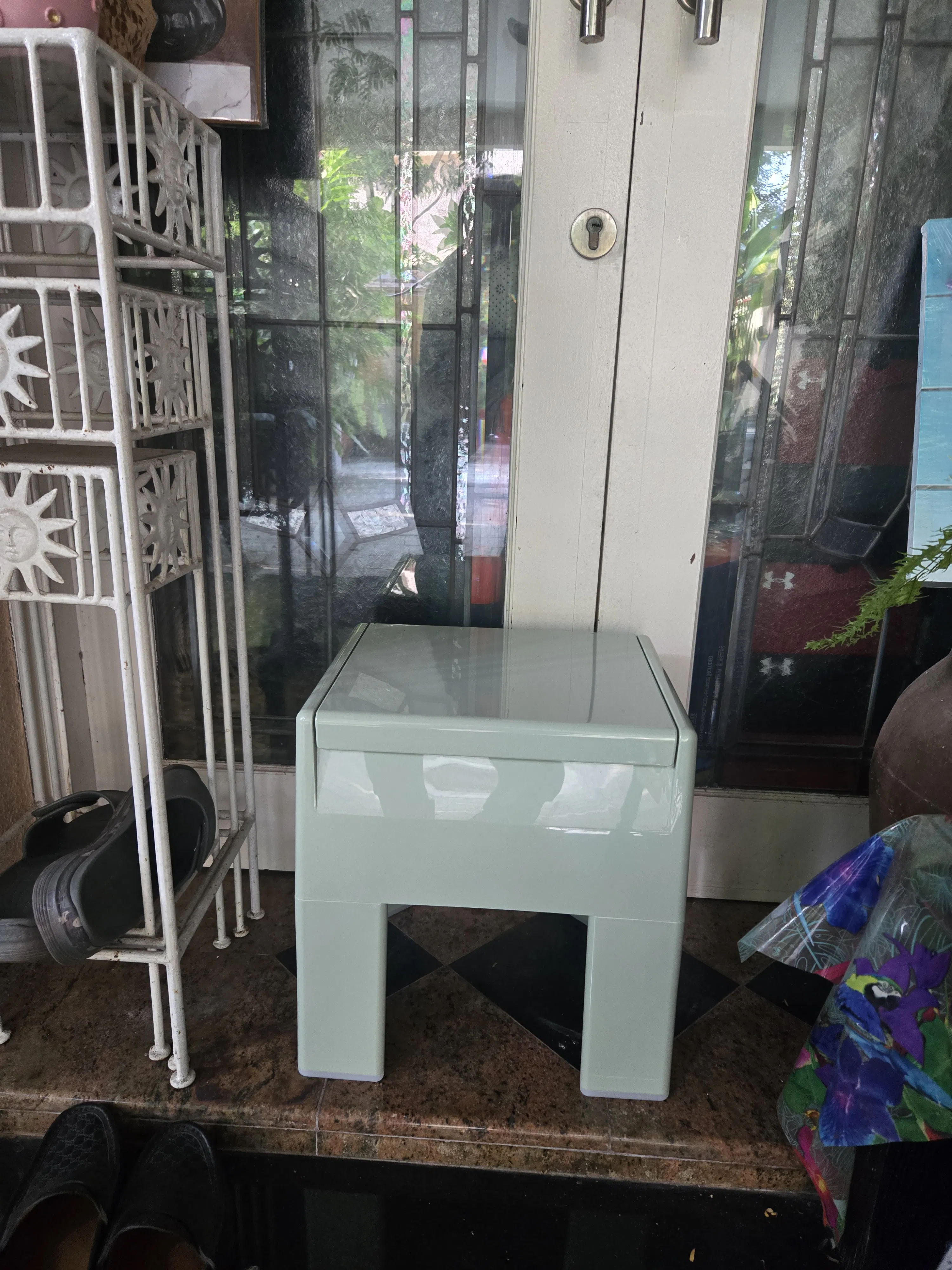Customer home photo 2: Located right in front of the house, it is an unusual stool to take off / wear our shoes. The small storage is very practical for our socks. 

Convenient & "good looking".