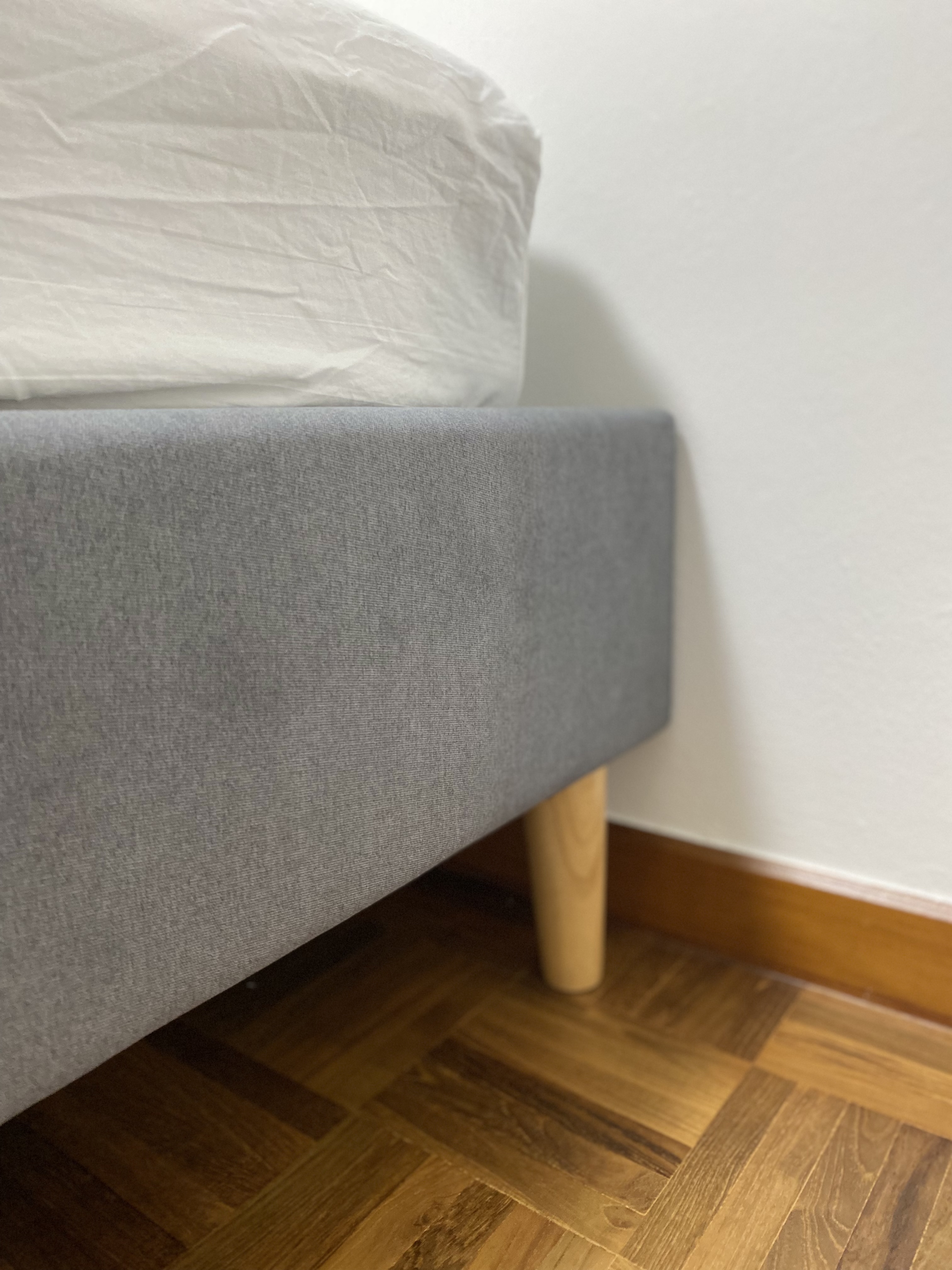 Customer home photo 11: Appreciate that it comes with free assembly. Overall good just note that the headboard is rather low so it’s about at half-body length if you sit upright. The actual gray colour is lighter than pictured but okay for me.