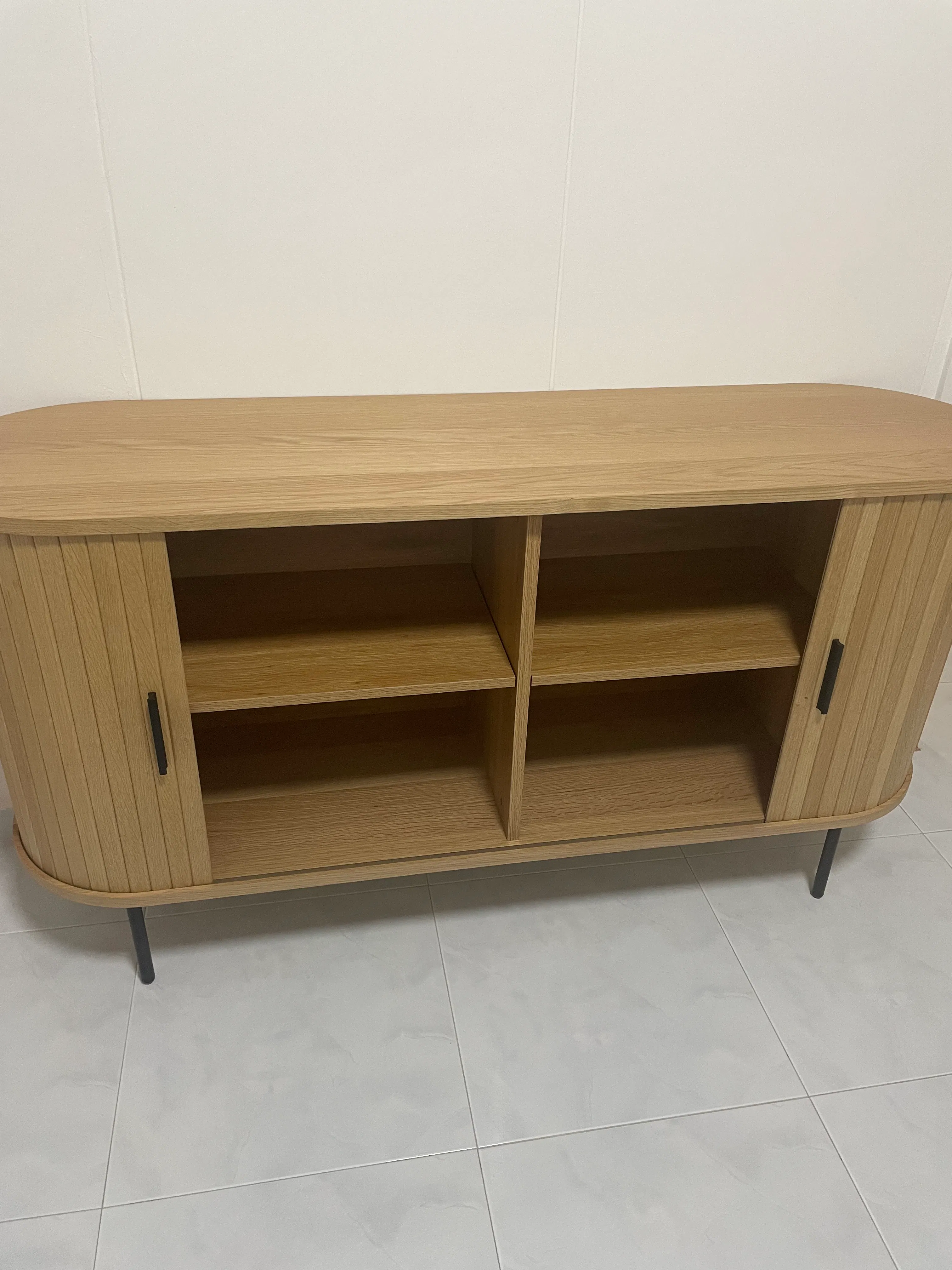 Customer home photo 3: The cabinet has a Scandinavian feel and it fits perfectly with my home deco theme. The material is in good condition. No unusual smell too. Installation was done within 15mins. Thank you for the prompt delivery too!