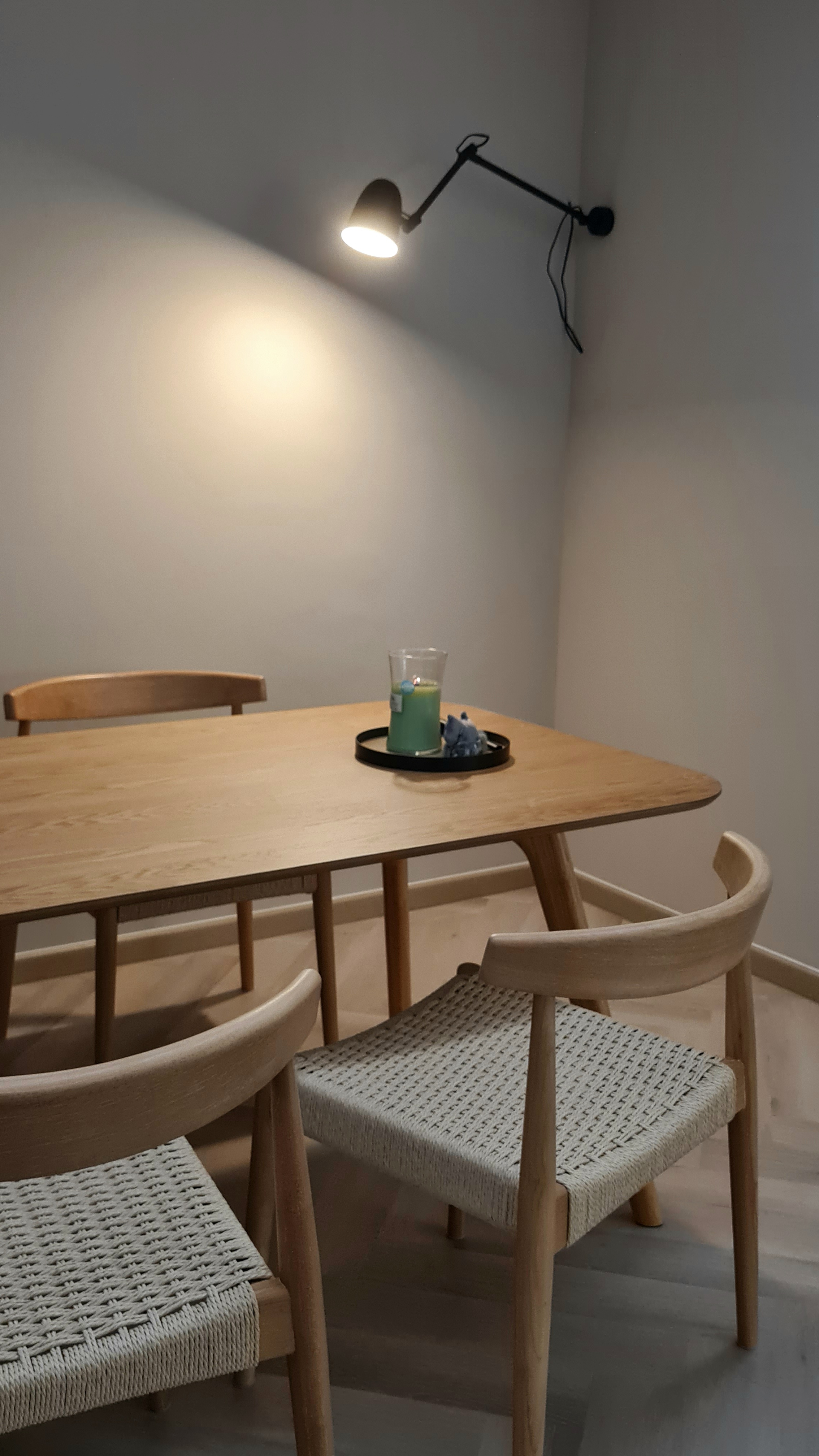 Customer home photo 4: A generous size dining table with beautiful   wood grains.  Love the rounded corners preventing painful knocks.  However table top seems abit wobbly as it doesn't sit flat on the legs support. There's a slight gap on each of the leg support so I slipped folded papers in between the gaps to stabilise the table top.