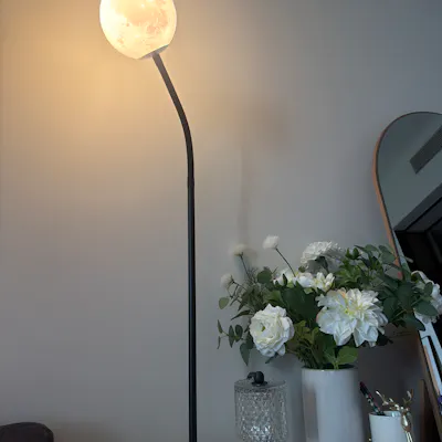 Customer home photo 1: Love that it looks like a moon! The bulb was not included so make sure you order bulb together when you order this lamp.
