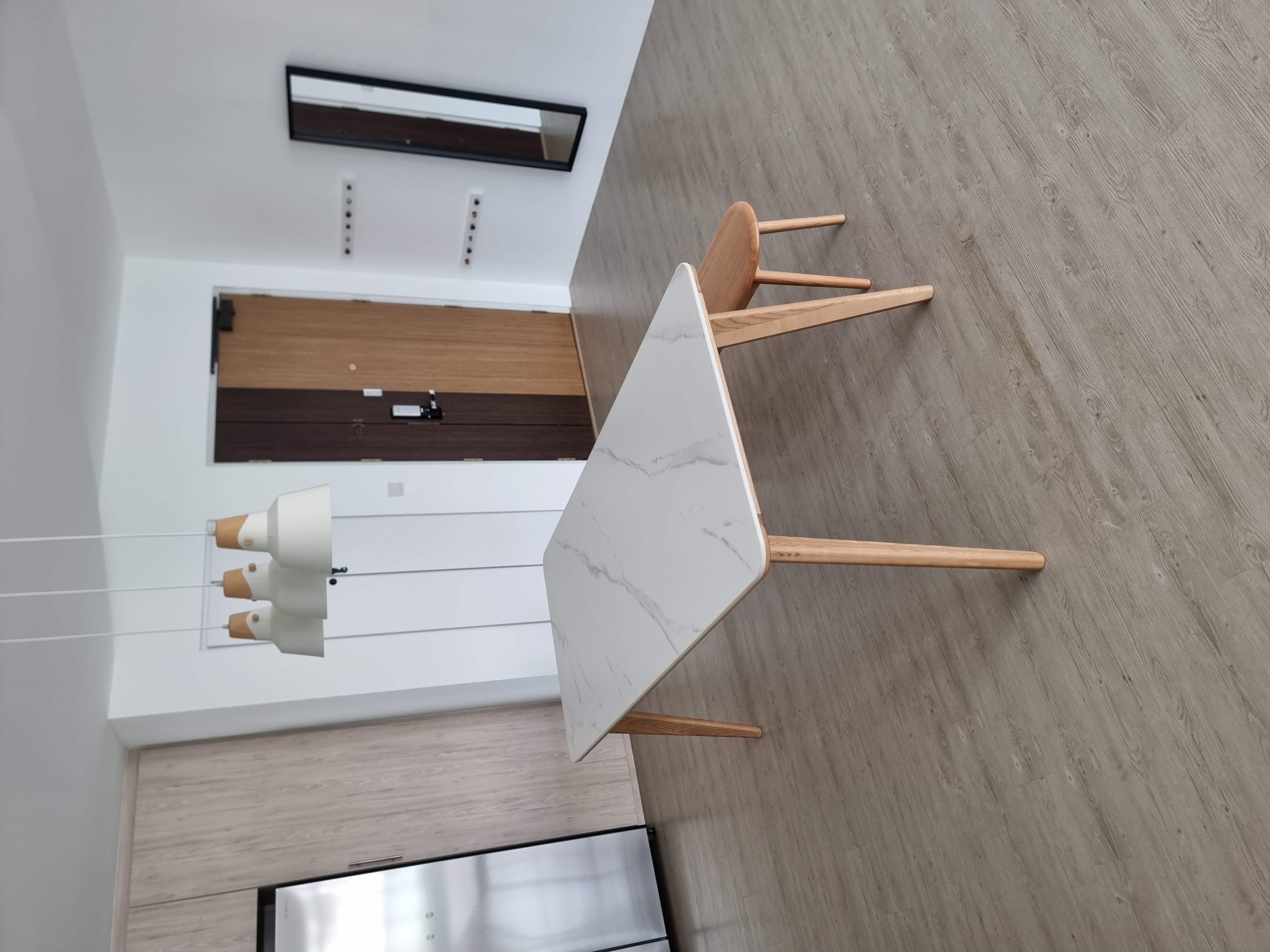 Customer home photo 3: Fits perfectly with the scandi theme of my apartment. Delivery was prompt, finishing is flawless! Table is solid and sturdy. Comes with floor protector stickers on the legs.
