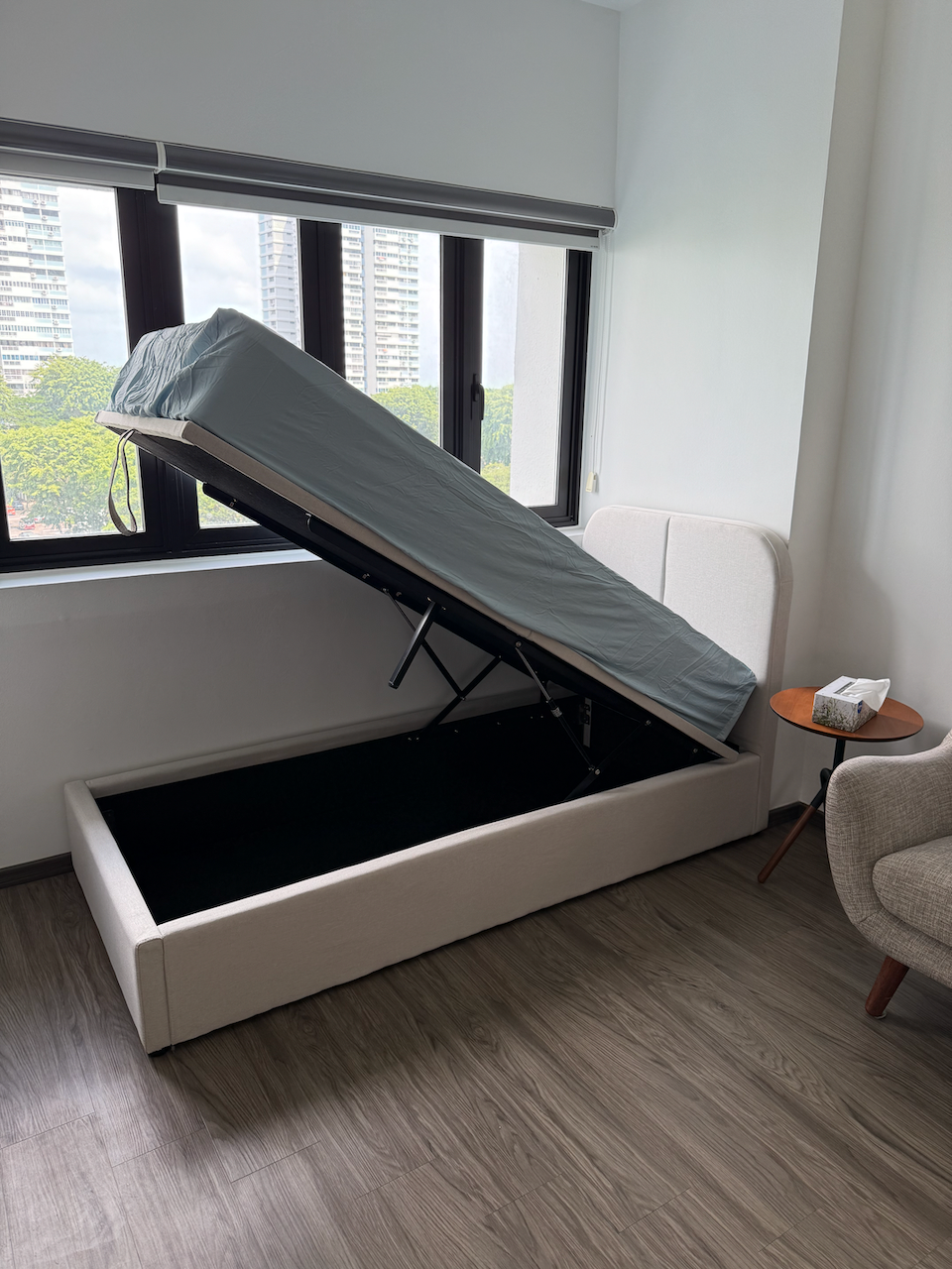 Customer home photo 3: Classy and functional bed. My wife loves the "modern and minimalist aesthetic". It's a standard single-sized bed, with big storage below. The storage is safely and easily accessible by lifting up the bed from the foot. It has pneumatic pistons to make it easier to lift, to hold the bed in place when accessing storage, and to let the bed come down gently once done. Perfect for 1 person to sleep on. The delivery team assembled fuss-free upon delivery.