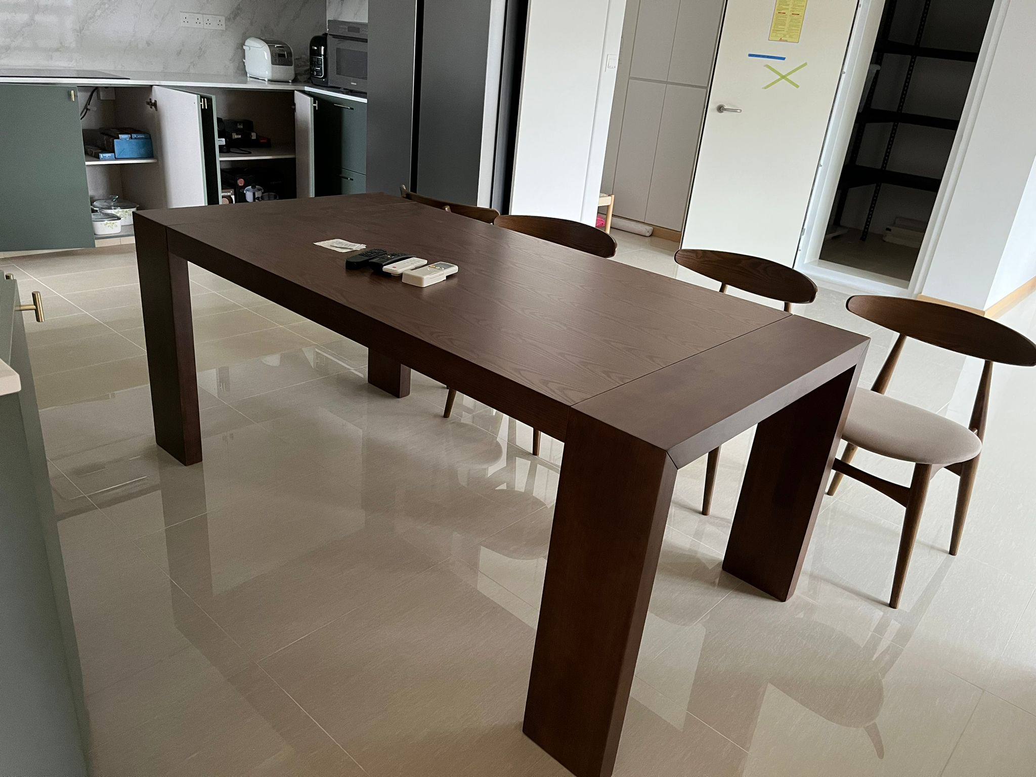 Customer home photo 2: Solid and sturdy dining table. Legs took up a fair bit of the purported length though.