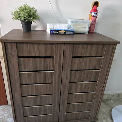 Customer home photo 3: Does the job of keeping shoes out of sight with grooves to air. Thin door does the job.