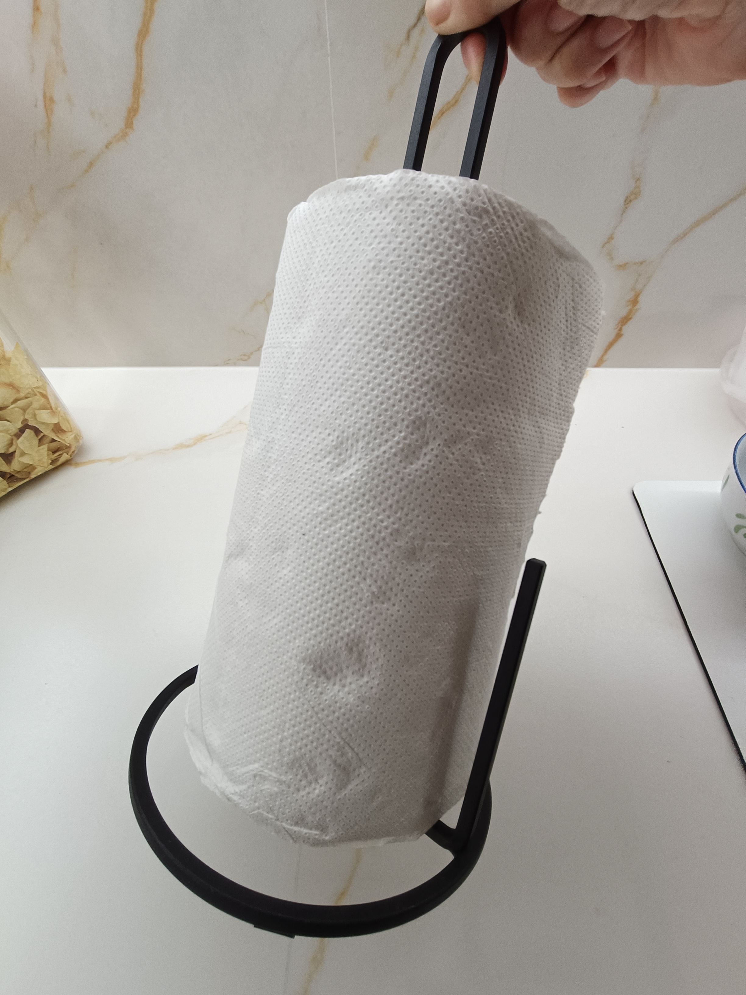 Customer home photo 2: This holder is very sturdy and it stays in place when you rip off a towel. It is heavy as it is made of wrought iron. Love the design of this towel holder.