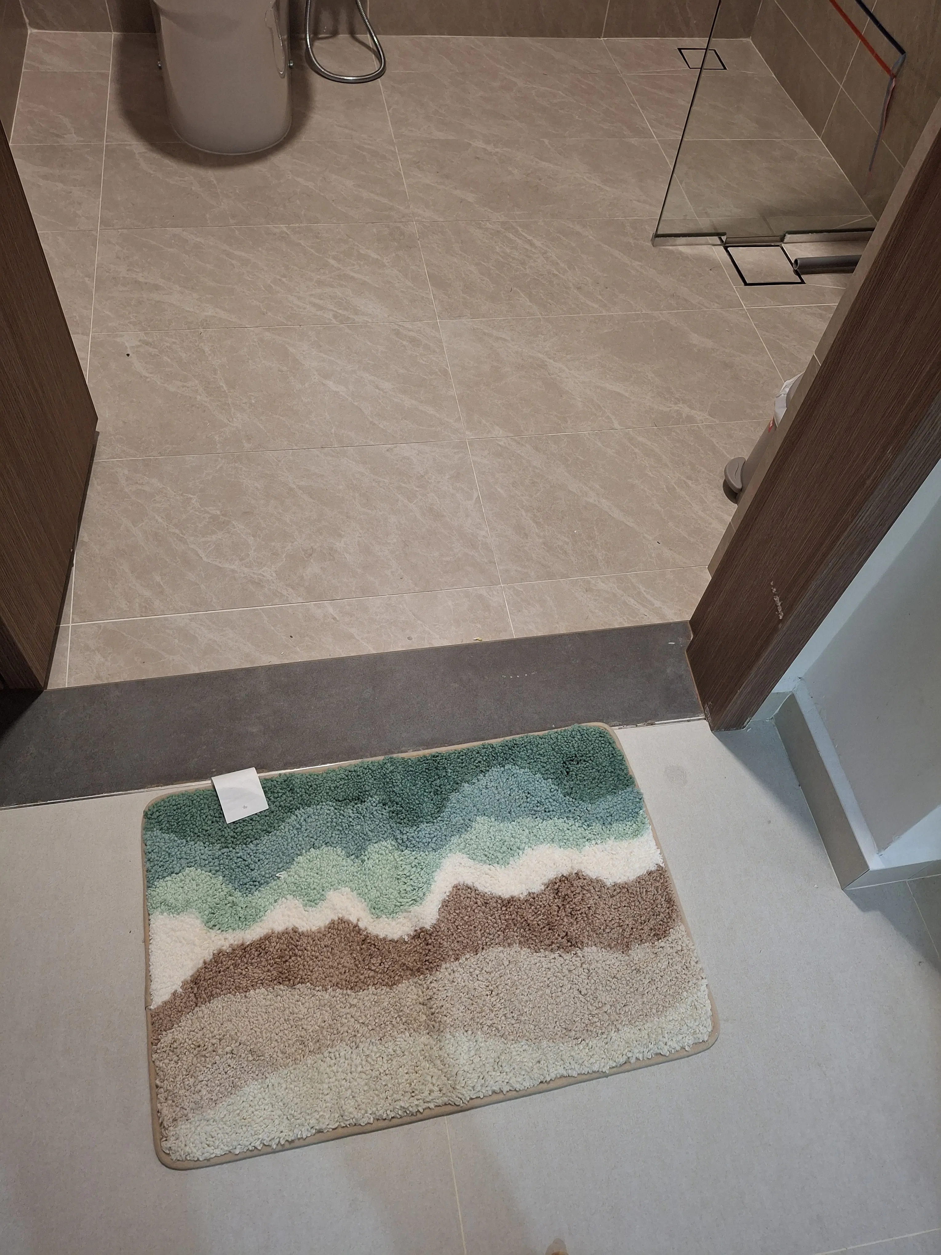 Customer home photo 3: It looks and feels nice and fits my Scandi theme for my 2-room BTO, plus it features some of my favourite colours. However, I don't find it as good for stepping on it with wet feet, compared to just a thin towel for drying the feet. I think it looks better than it functions 🤷‍♀️
