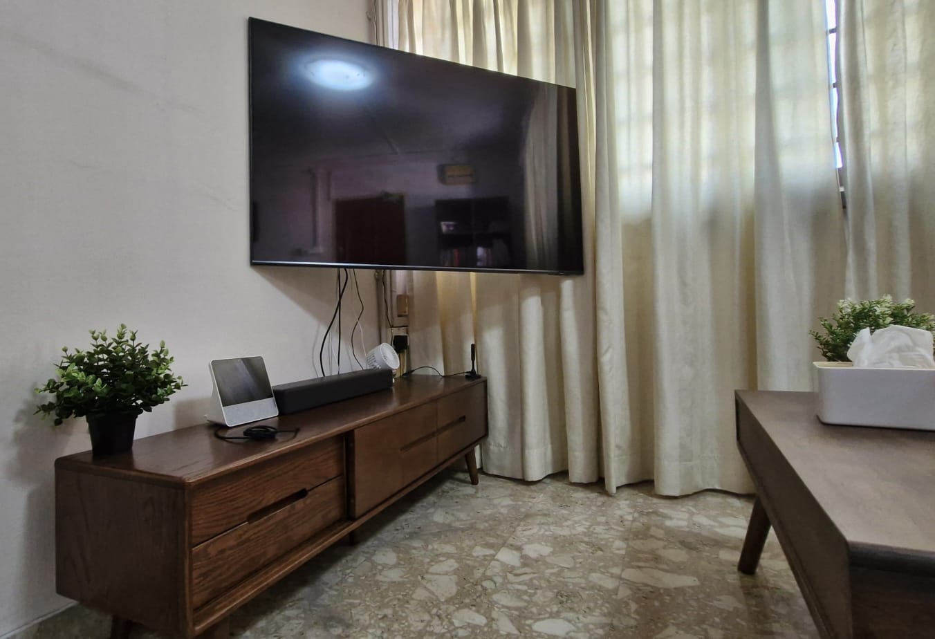 Customer home photo 19: It is not too bulky, made of solid wood. Size is suitable for 55 inch TV mounted on wall. Space below allows cleaning.