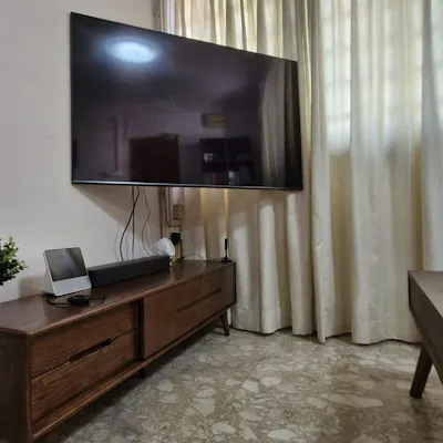 Customer home photo 19: It is not too bulky, made of solid wood. Size is suitable for 55 inch TV mounted on wall. Space below allows cleaning.