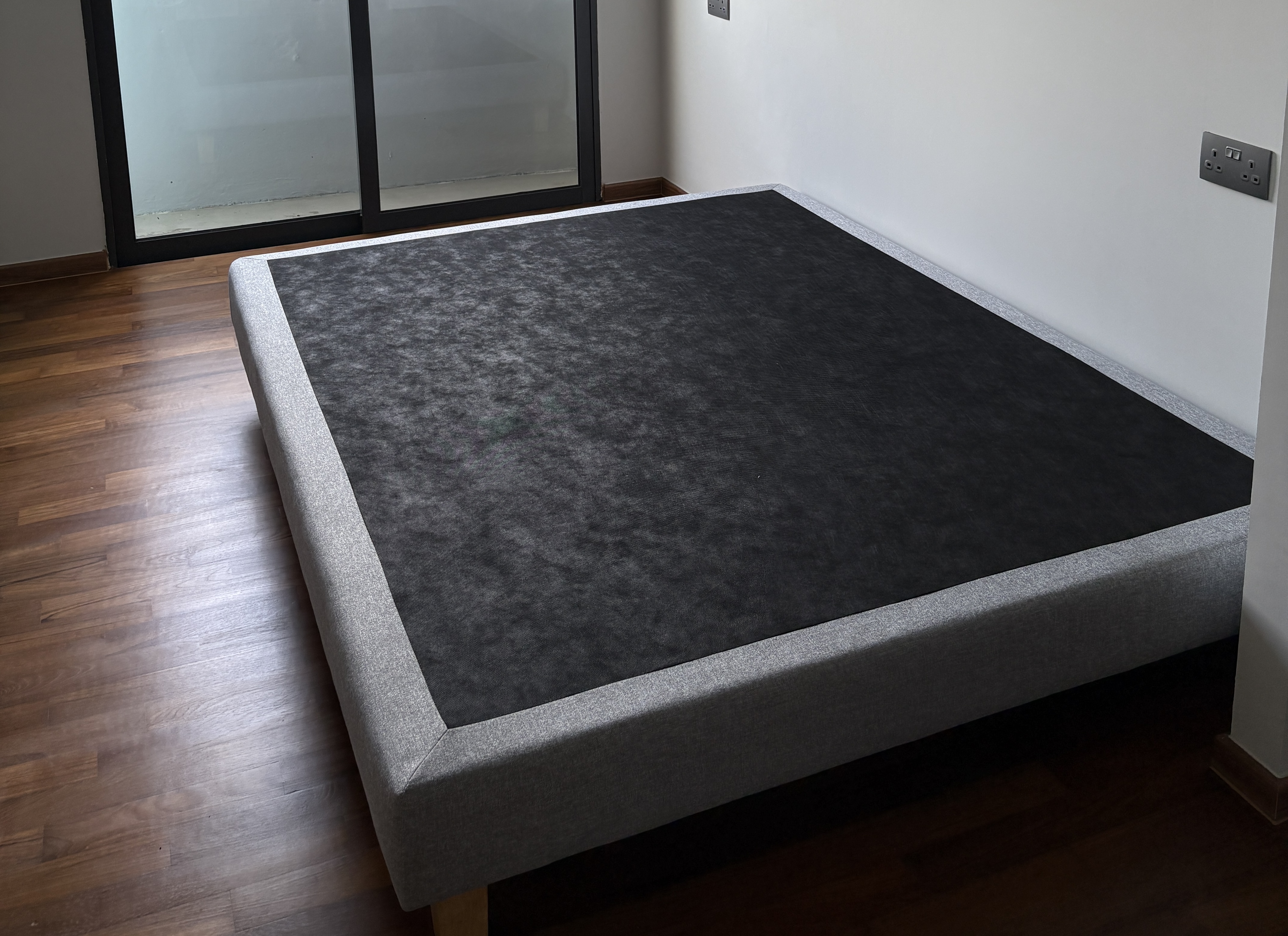 Customer home photo 2: The bed frame is surprisingly lightweight yet sturdy. Easy to move around with one person. Love the simple look of it, easy to match with my theme.
