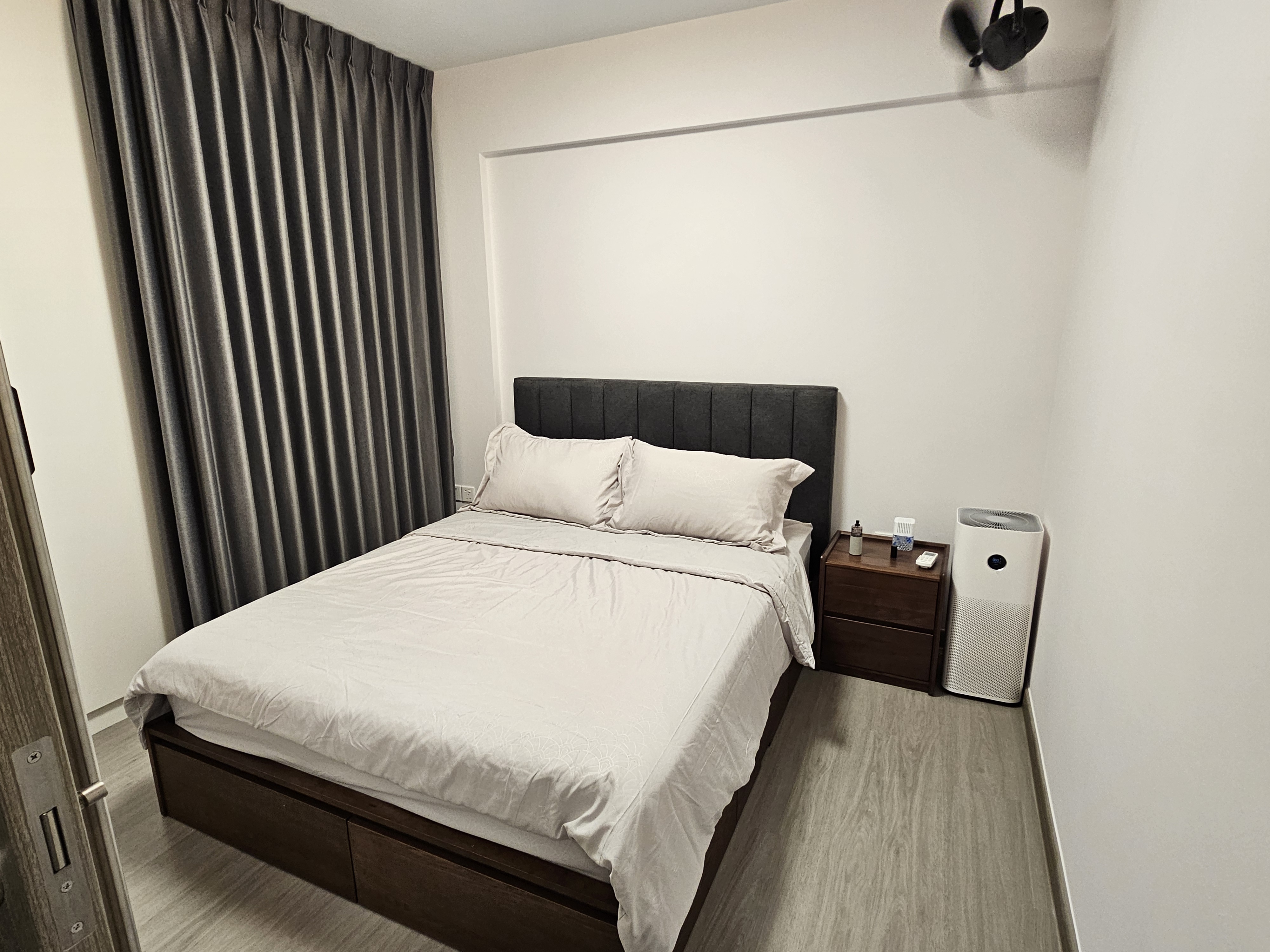 Customer home photo 2: Beautiful walnut wood bedframe. That fits my colour scheme! Good solid wood, smooth drawers at four sides! Headboard ia dark grey cushion fabric that matches my curtains. Love the colours, super cozy feel.