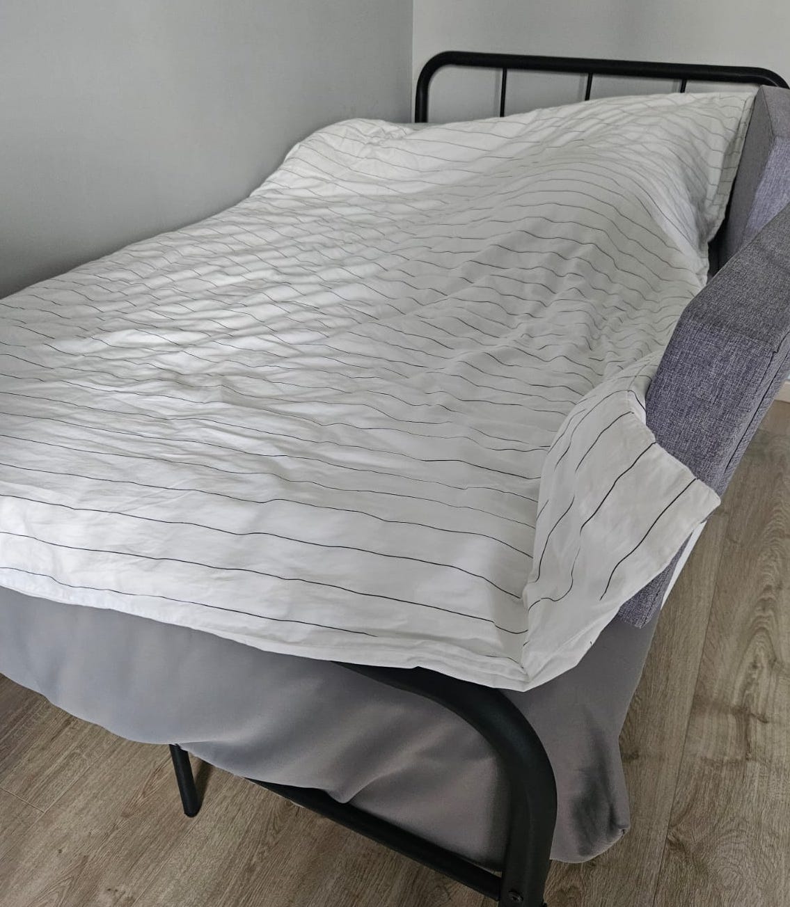 Customer home photo 1: There was an update of detailed delivery timing in the days leading up to the delivery date which I appreciate very much. The delivery guys came within the time frame stated, although it was the last 5min. The guys were polite and neat, and worked quickly to set up the bed. They cleaned up the space after they're done too. The bed is powder coated, so hopefully that'd help with the rust issue. It is sturdier than I'd expected, and my child really enjoyed staying in it. That said, I was a bit sad cos when I 1st wanted to buy it was $80, and then a week later, the price almost doubled.