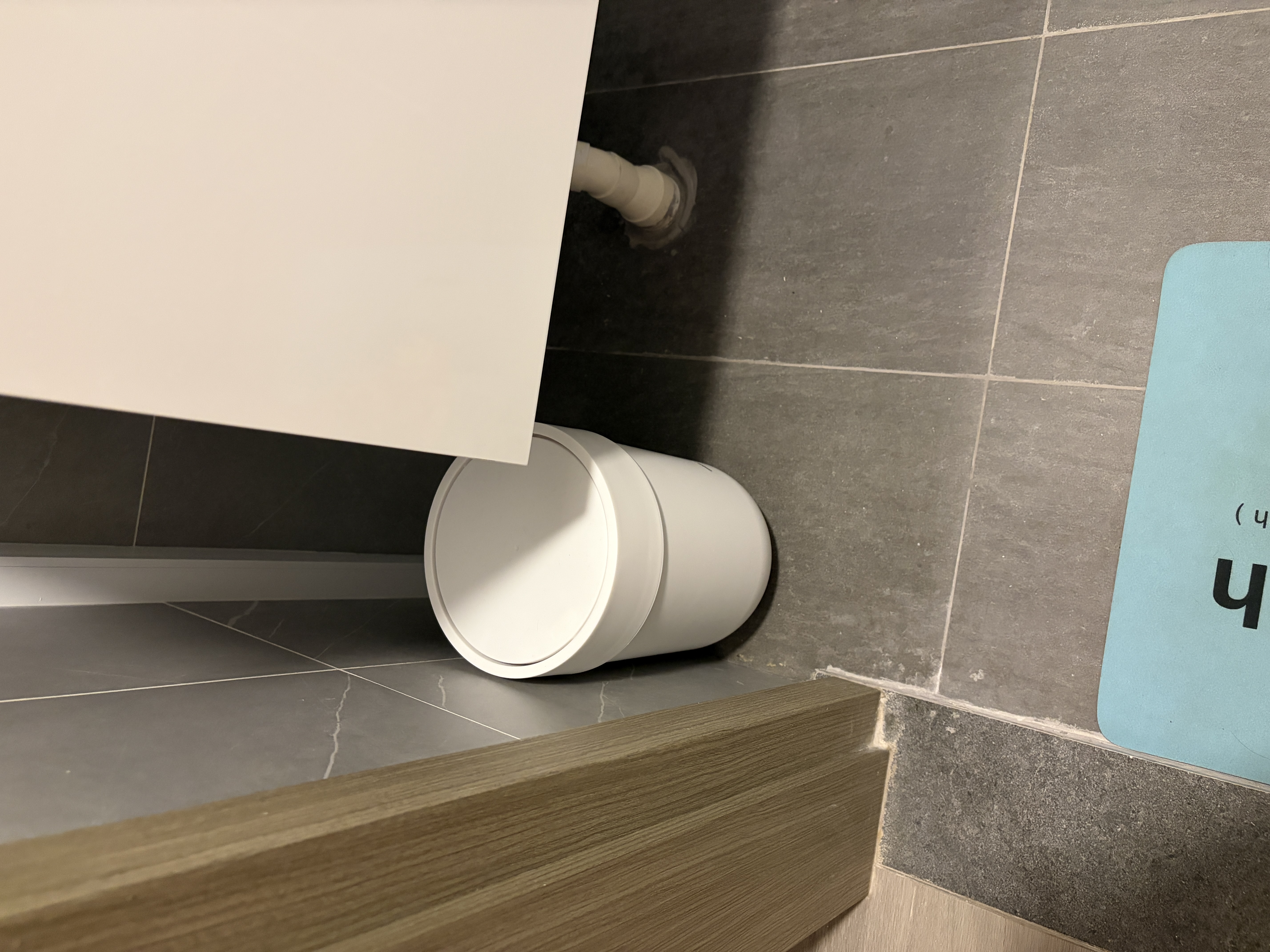 Customer home photo 1: The white trash can fits nicely in my bathroom and it's waterproof