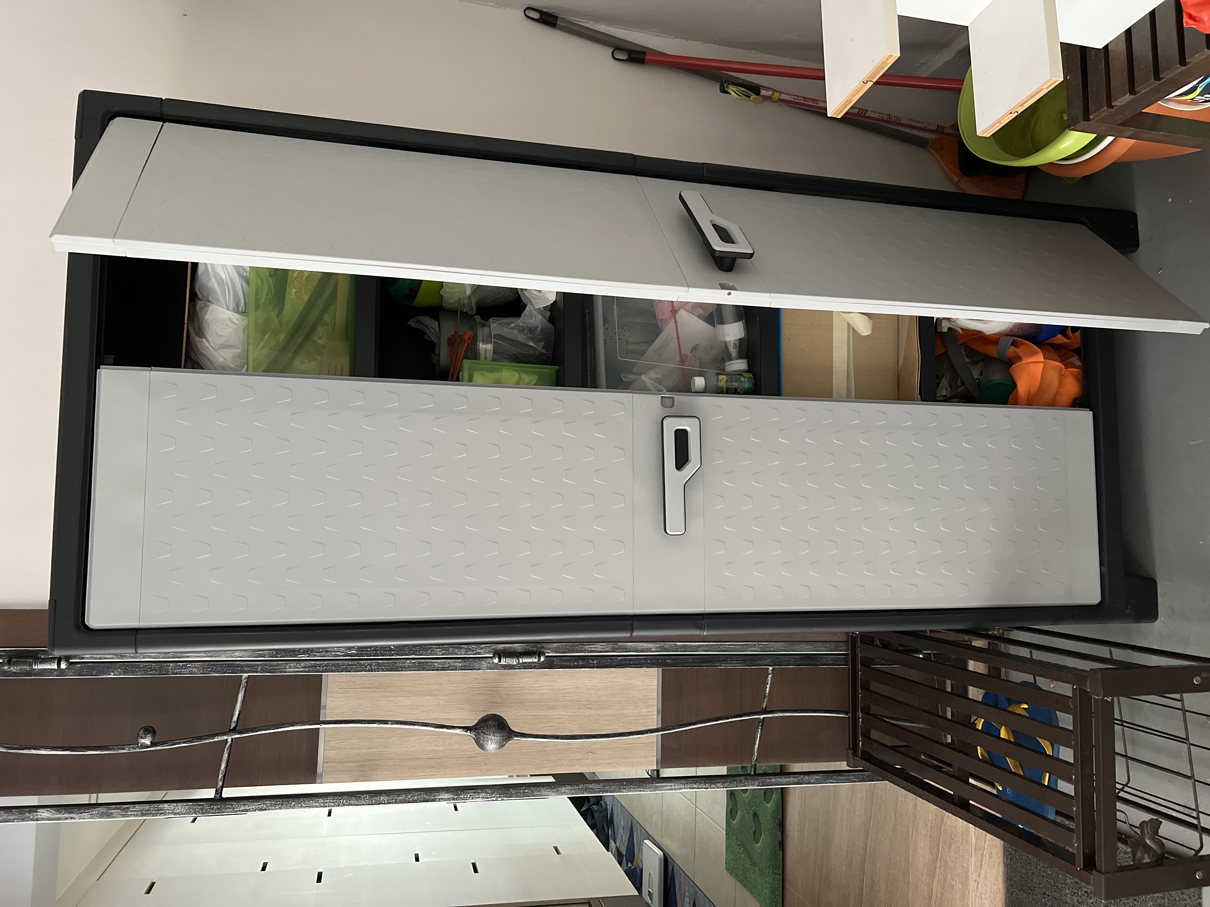 Customer home photo 3: I m so glad tt I have this Titan Utility Outdoor Cabinet, because all along I kept my plants stuff ie pots/ little stones / plants accessories inside my house n now I found a perfect cupboard sturdy n big enough to keep all plant stuff outside the house! Thanks Hipvan!