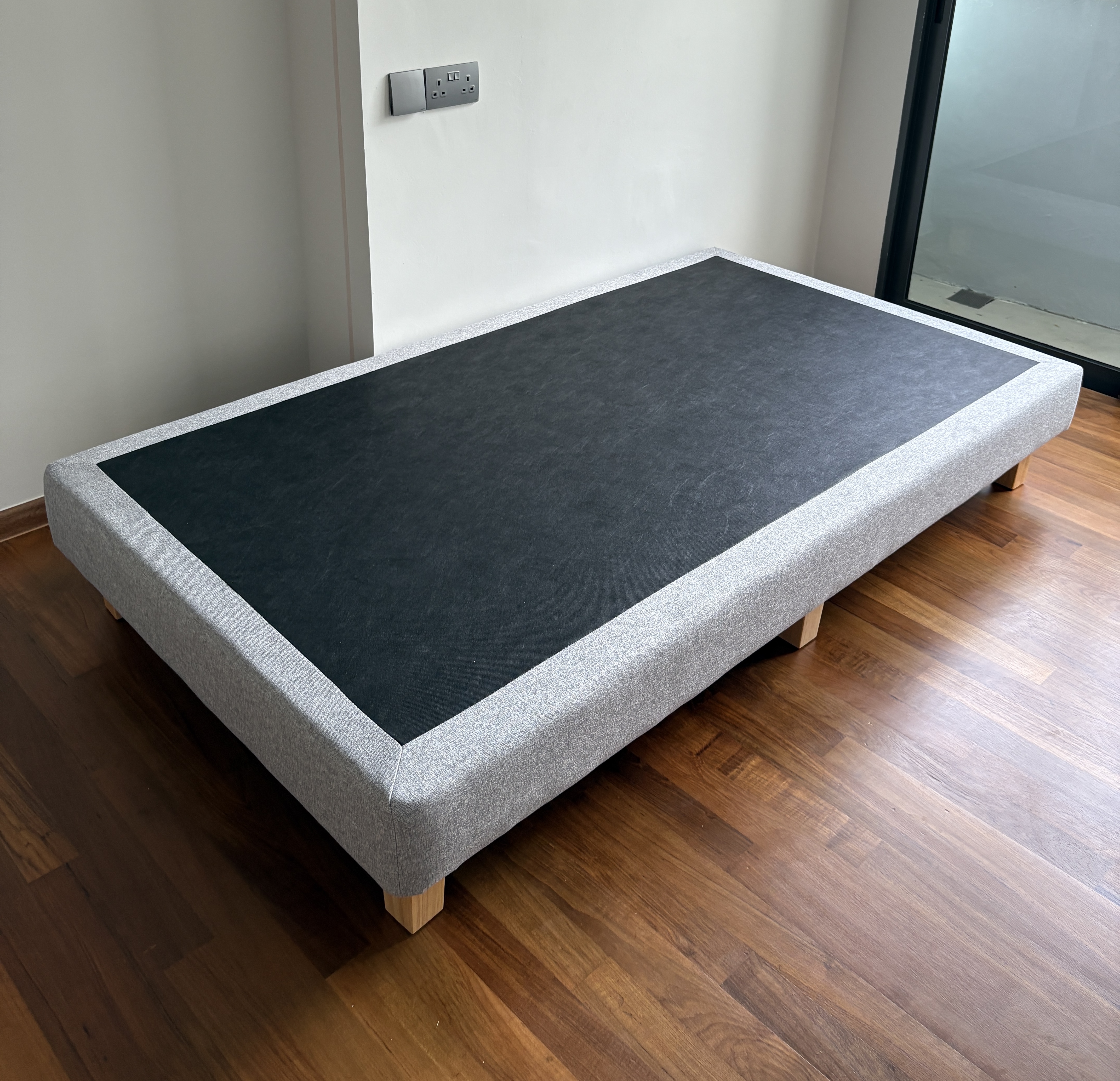 Customer home photo 1: The bed frame is surprisingly lightweight yet sturdy. Easy to move around with one person. Love the simple look of it, easy to match with my theme.