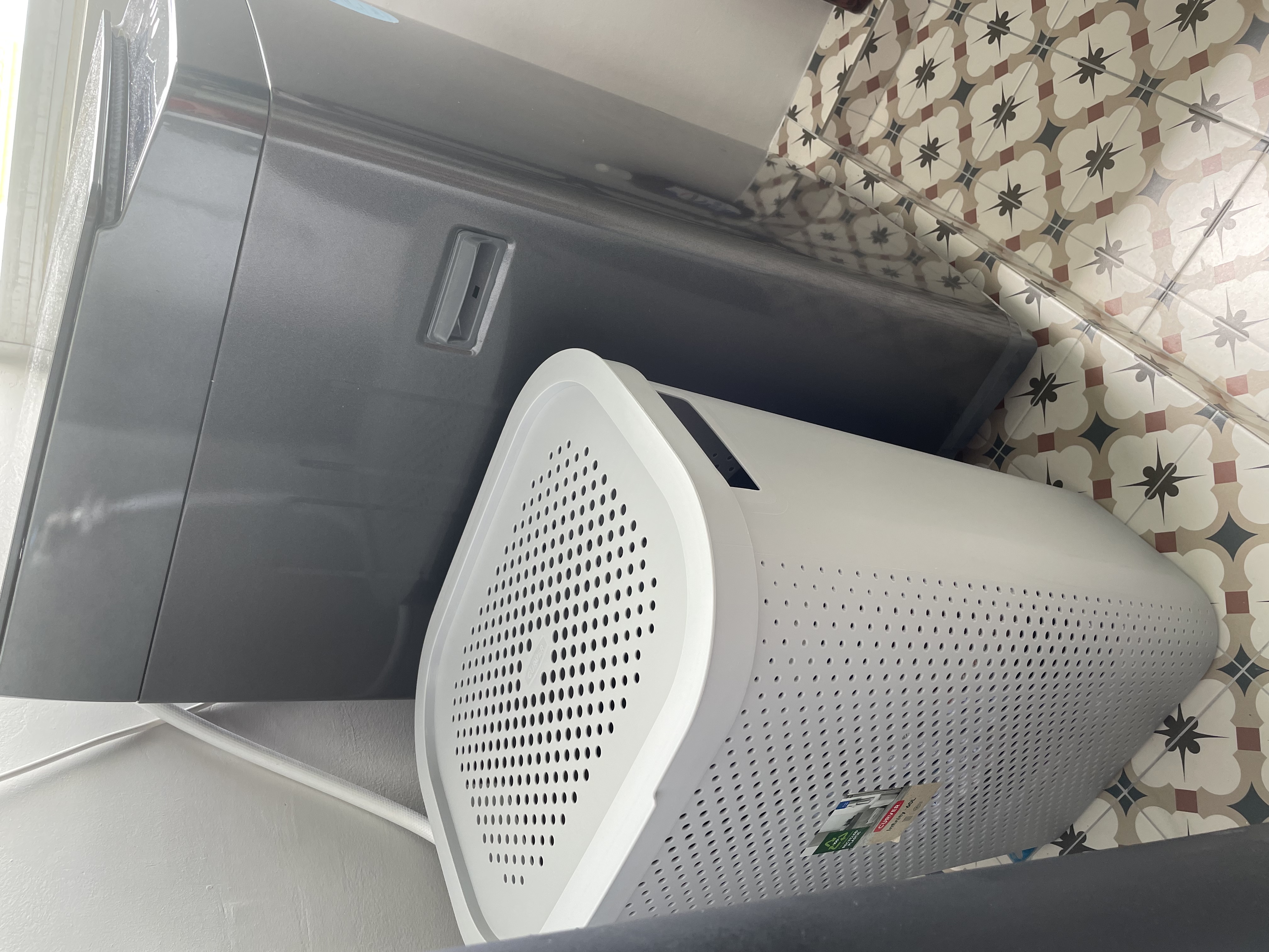 Customer home photo 4: Nice laundry basket. Right size for 2 person. Nice slim design that fits in the space in between the pipe and washer.