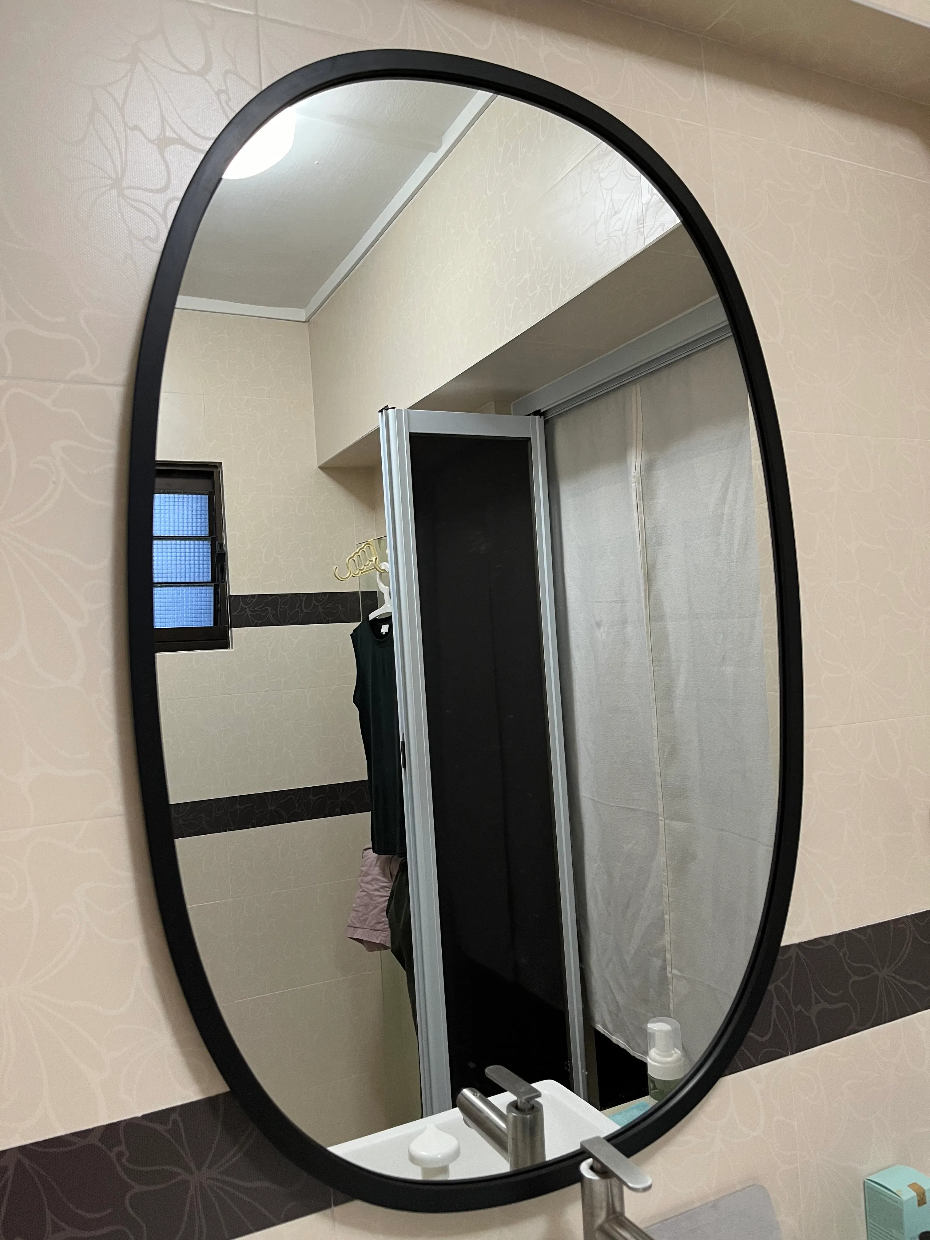 Customer home photo 1: Looking for a good size mirror with black frame and found this on HipVan. It’s a black rubber casing, there’s a visible joint at the side if you hang it like I do. Not a big issue for me. There two brackets provided for whichever placement you want to hang. Not suitable as a free standing mirror coz of the shape. Happy with the purchase.