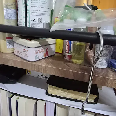 Customer home photo 1: This is a compact table and serves its functions. I like the strong bars which allow me to hook items