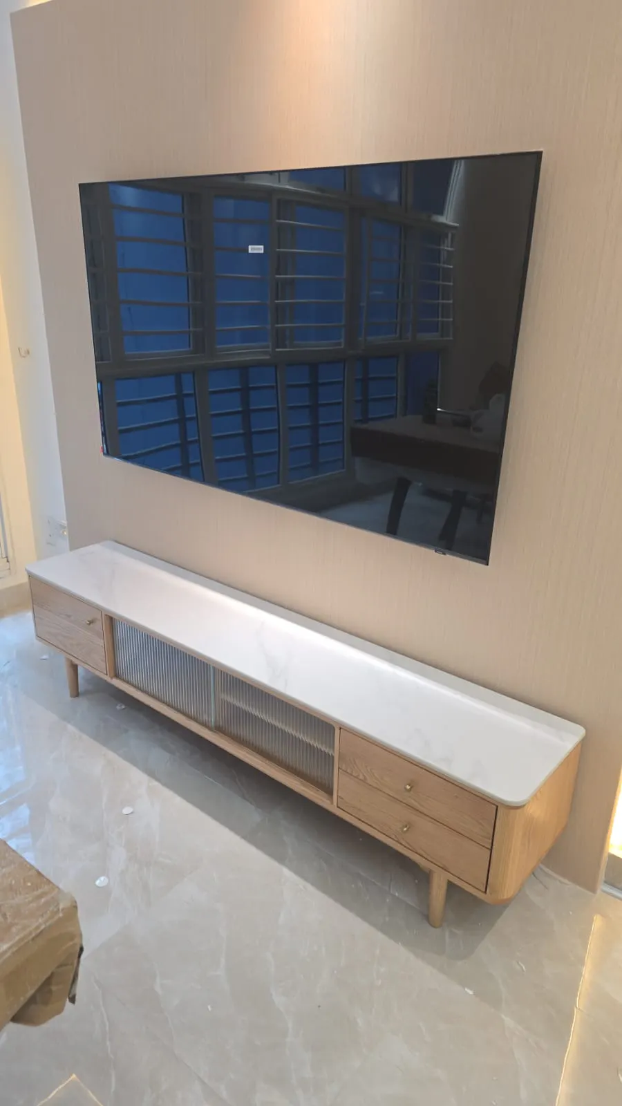 Customer home photo 24: Great TV console wanted to do a build in hanging TV console but I saw this in hipvan with sintered stone and the design it's very good for the price and design match our home theme and great to use where I also can hide my small vacuum robot under it without any hassle.