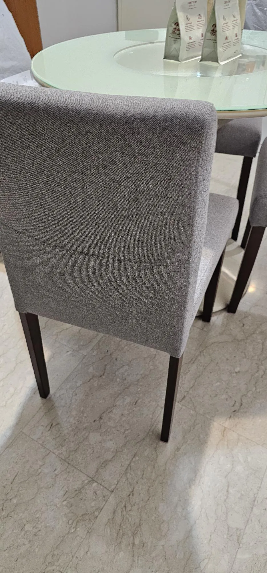 Customer home photo 1: I like the quality of the chairs and the light weight (to my surprise, despite the oak legs). But on the website, the chair looks brighter and more beige than it is in person. The legs are significantly darker, and the dolphin grey doesn't have even a slight beige tone in it. Thus, if you're a person who's very particular about how the furniture matches together, you should be careful with this. Look more at the testimonial side and real pictures from other buyers.