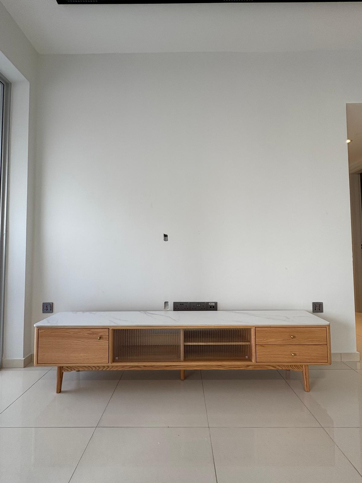 Customer home photo 25: I recently purchased the Aster TV Console (2m) from HipVan and I couldn't be happier with the quality and design! The console looks even better in person — the combination of natural oak wood, sintered stone top, and fluted glass doors adds a modern yet elegant touch to my living room.

It feels solid and premium, with smooth sliding doors and a sturdy build. The storage is practical, with ample space for my consoles, remotes, and decor. I also appreciate the cable management slot at the back, which helps keep everything neat and tidy.

Delivery was smooth and on time, and the team assembled it perfectly on-site.

Highly recommend this if you're looking for a statement piece that's both functional and beautiful. Worth every dollar!