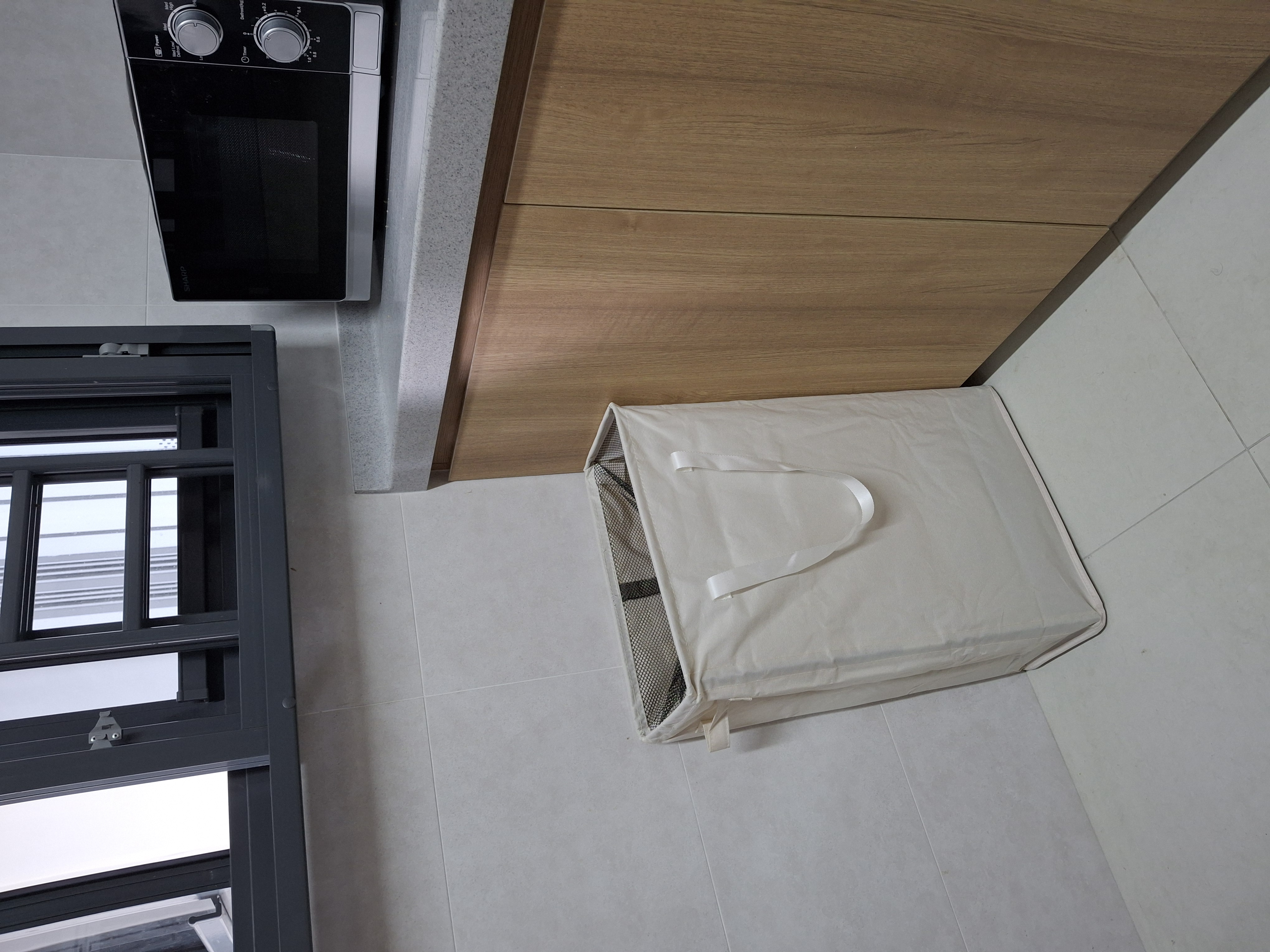 Customer home photo 4: I was quite surprised  that it can hold quite alot of laundry. I like it as it is slim and doesn't take too much space in my small kitchen